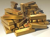 Goldbarren aufgestappelt.