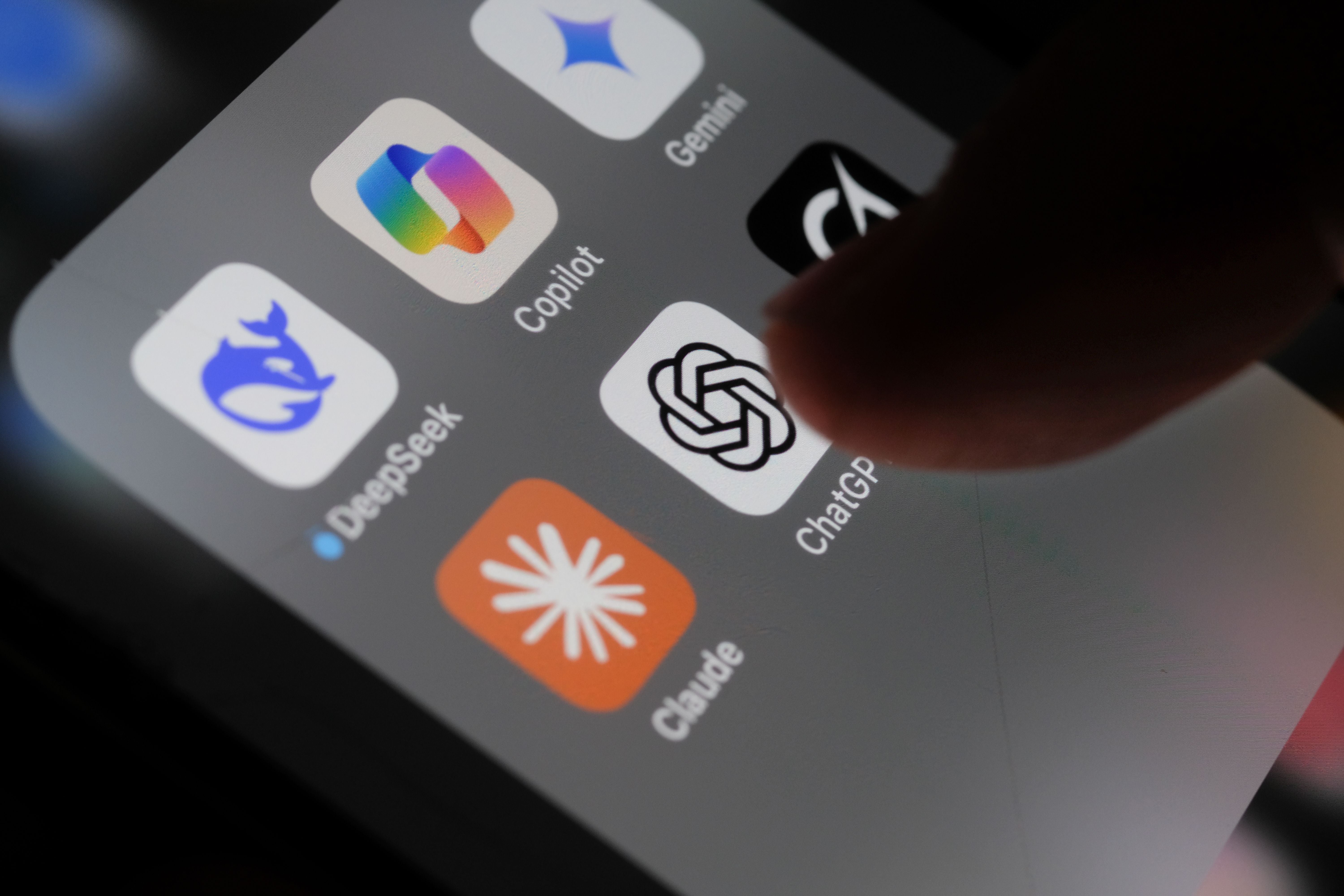 London, UK - 05 03 2025: Apple iPhone screen with Artificial Intelligence icons internet AI app application ChatGPT, DeepSeek, Gemini, Copilot, Grok, Claude, etc.
