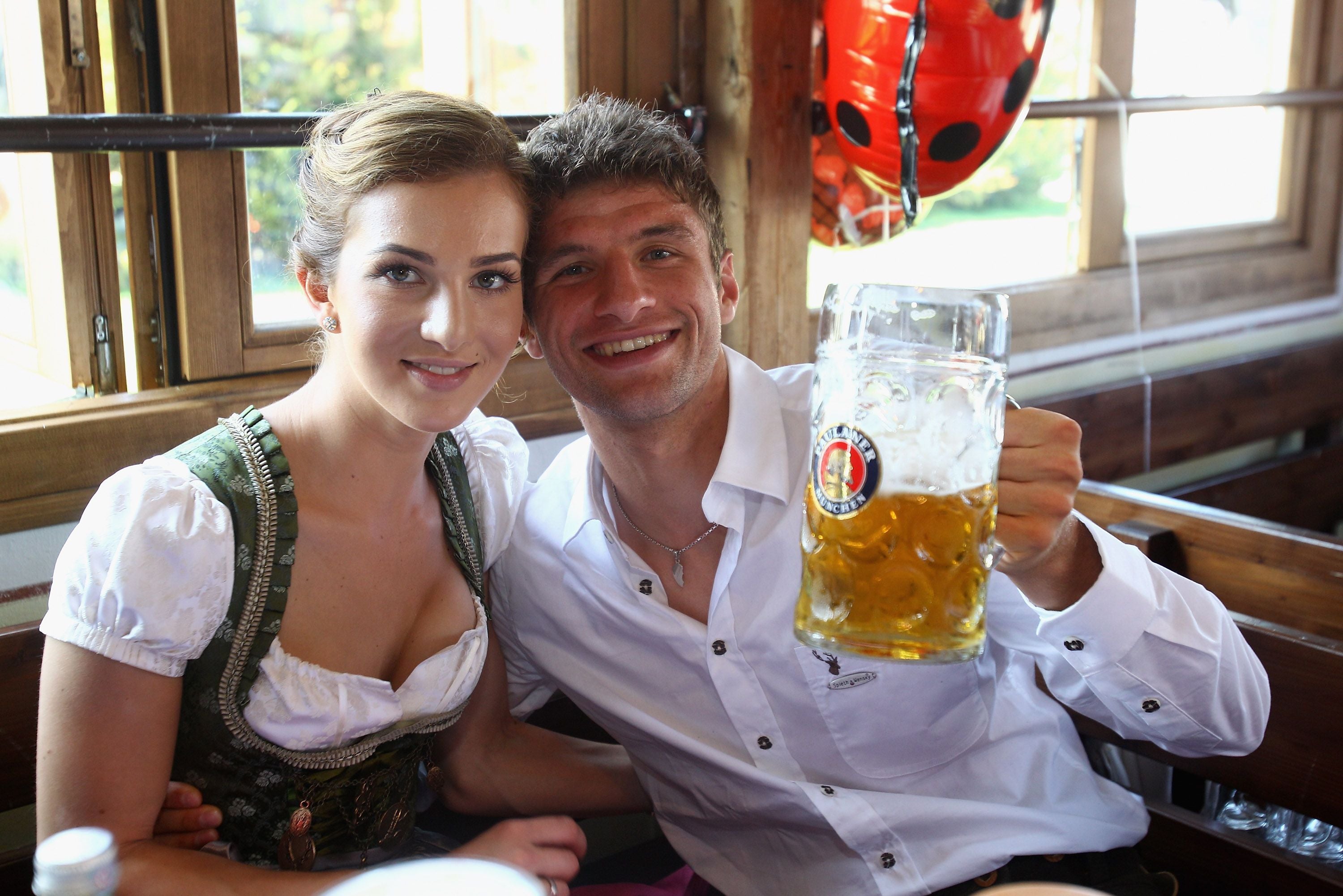 MUNICH, GERMANY - OCTOBER 02: Thomas Mueller of FC Bayern Muenchen attends with his wife Lisa Mueller the Oktoberfest beer festival at the Kaefer Wiesnschaenke tent on October 2, 2011 in Munich, Germany. (Photo by Alexander Hassenstein/Bongarts/Getty Images)