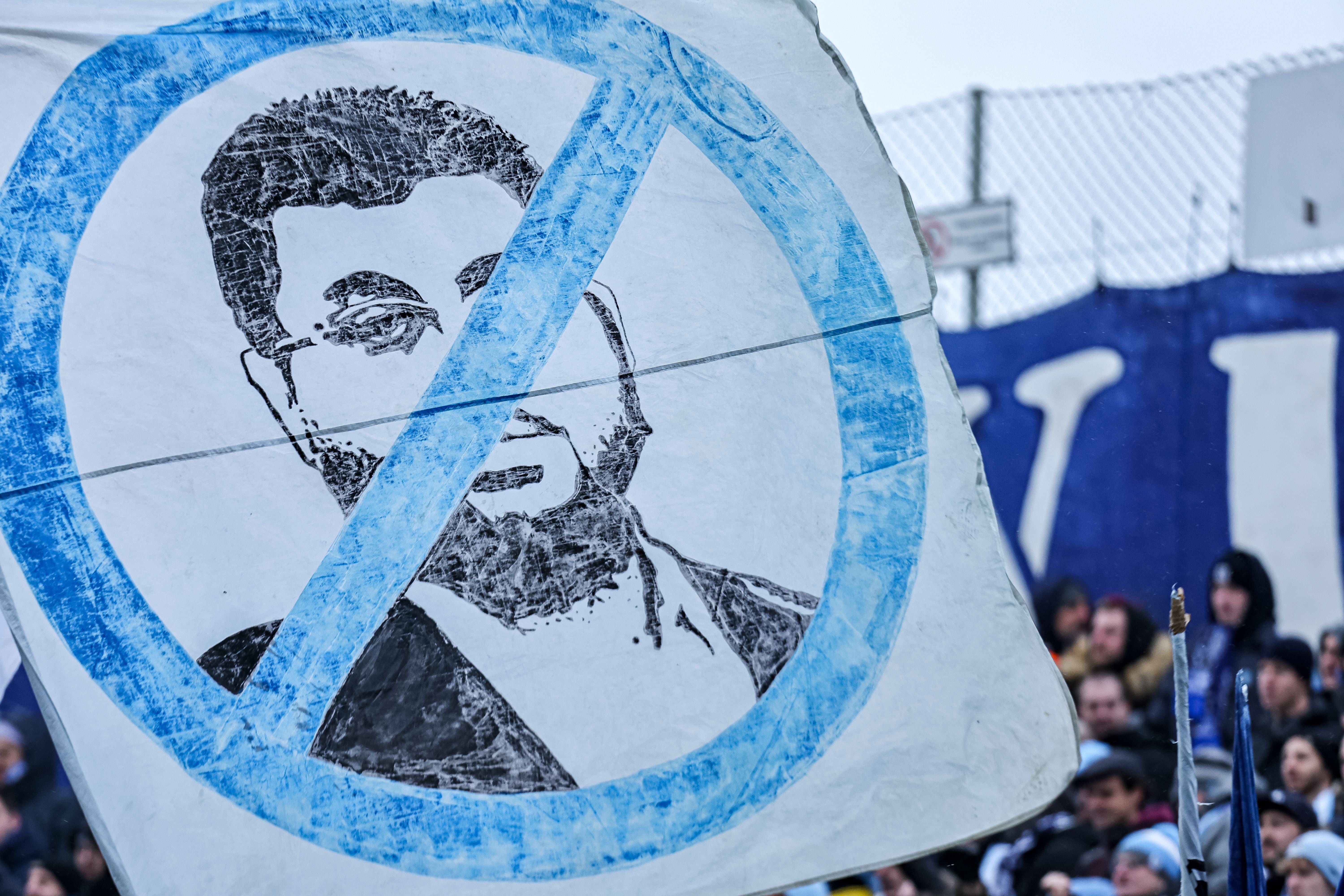 MUNICH, GERMANY - NOVEMBER 25: Fans of TSV 1860 show a poster with the investor Hasan Ismaik's face crossed outduring the 3. Liga match between TSV 1860 München and SpVgg Unterhaching at Stadion an der Gruenwalder Straße on November 25, 2023 in Munich, Germany. (Photo by Leonhard Simon/Getty Images)