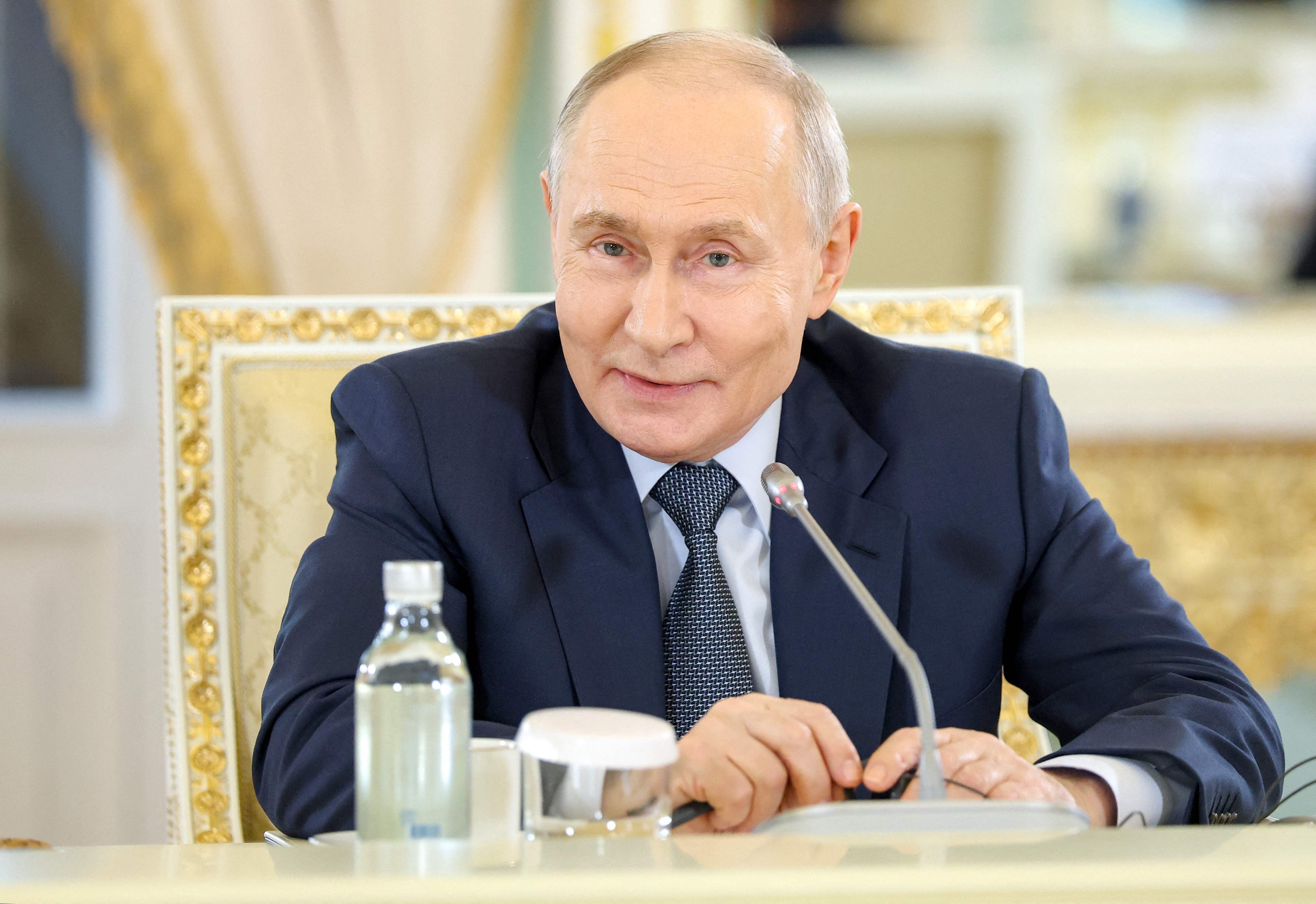 In this pool photograph distributed by the Russian state agency Sputnik, Russia's President Vladimir Putin meets with representatives of international news agencies on the sidelines of the St. Petersburg International Economic Forum at the Constantine Palace in Saint Petersburg on June 4, 2026. (Photo by Valery SHARIFULIN / POOL / AFP)