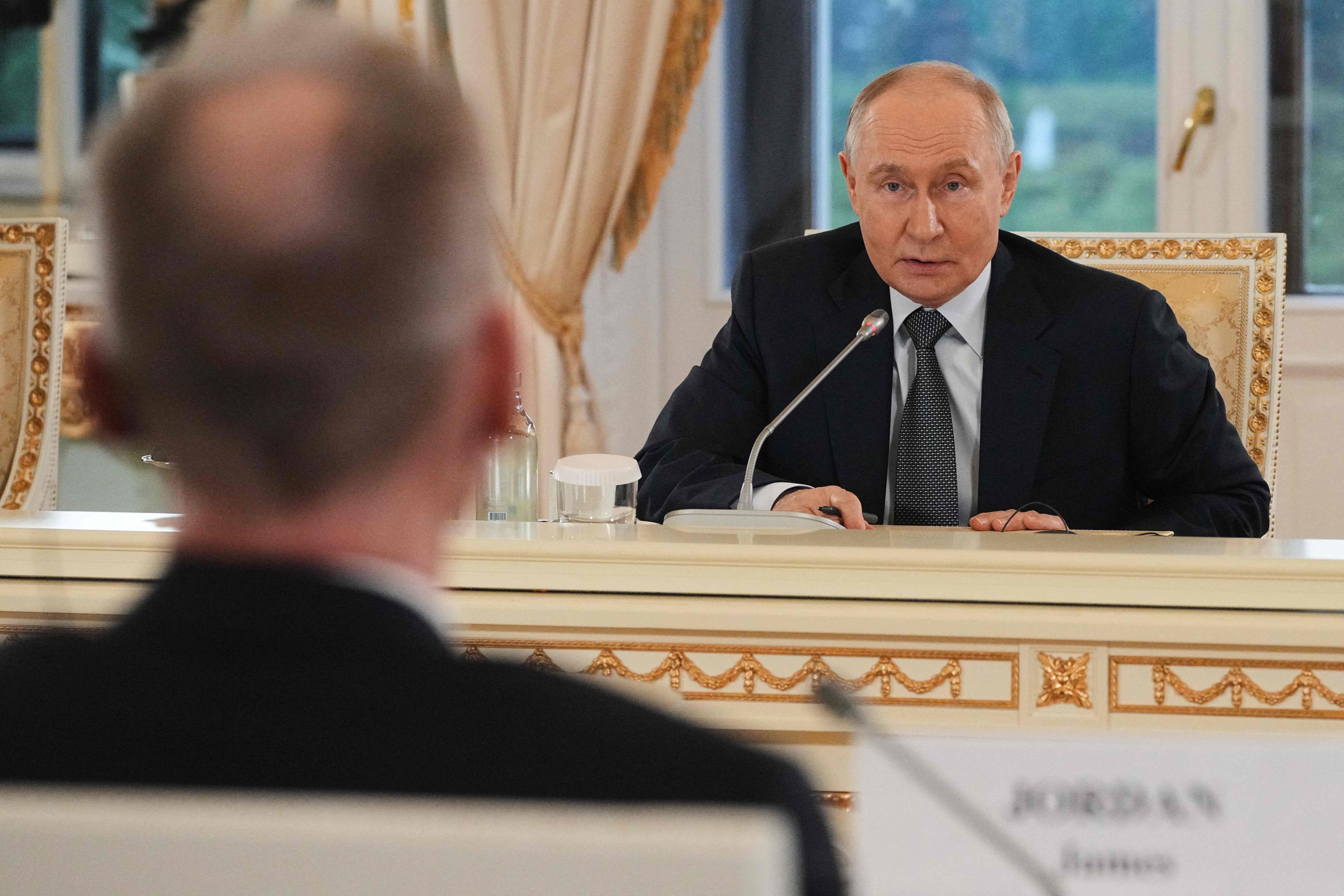 Russian President Vladimir Putin answers to a question by The Associated Press News Director of Europe/Africa James Jordan during a meeting with representatives of international news agencies on the sidelines of the St. Petersburg International Economic 'Forum 'at the Constantine Palace in Saint Petersburg on June 4, 2026. (Photo by Dmitry LOVETSKY / POOL / AFP)
