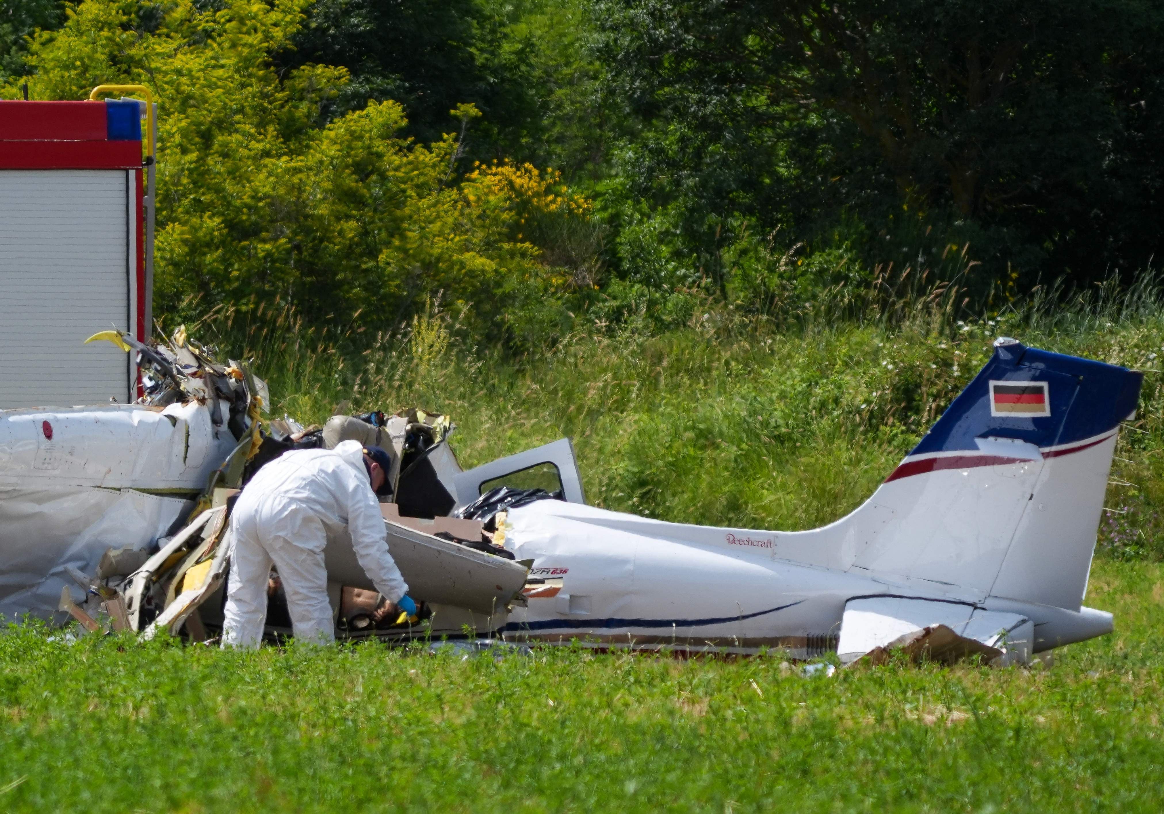 A police officer in protective gear collects evidences at site of a small plane crash, which killed 4 people, in Medulin on Croatia's northern Adriatic coast, on June 4, 2026. The accident occurred in the Campanoz area, outside the town, and 'all emergency services are on the scene'. According to the state-run HRT broadcaster, it was a small aircraft registered in Germany, which had taken off from Austria with Medulin as its destination. (Photo by AFP)
