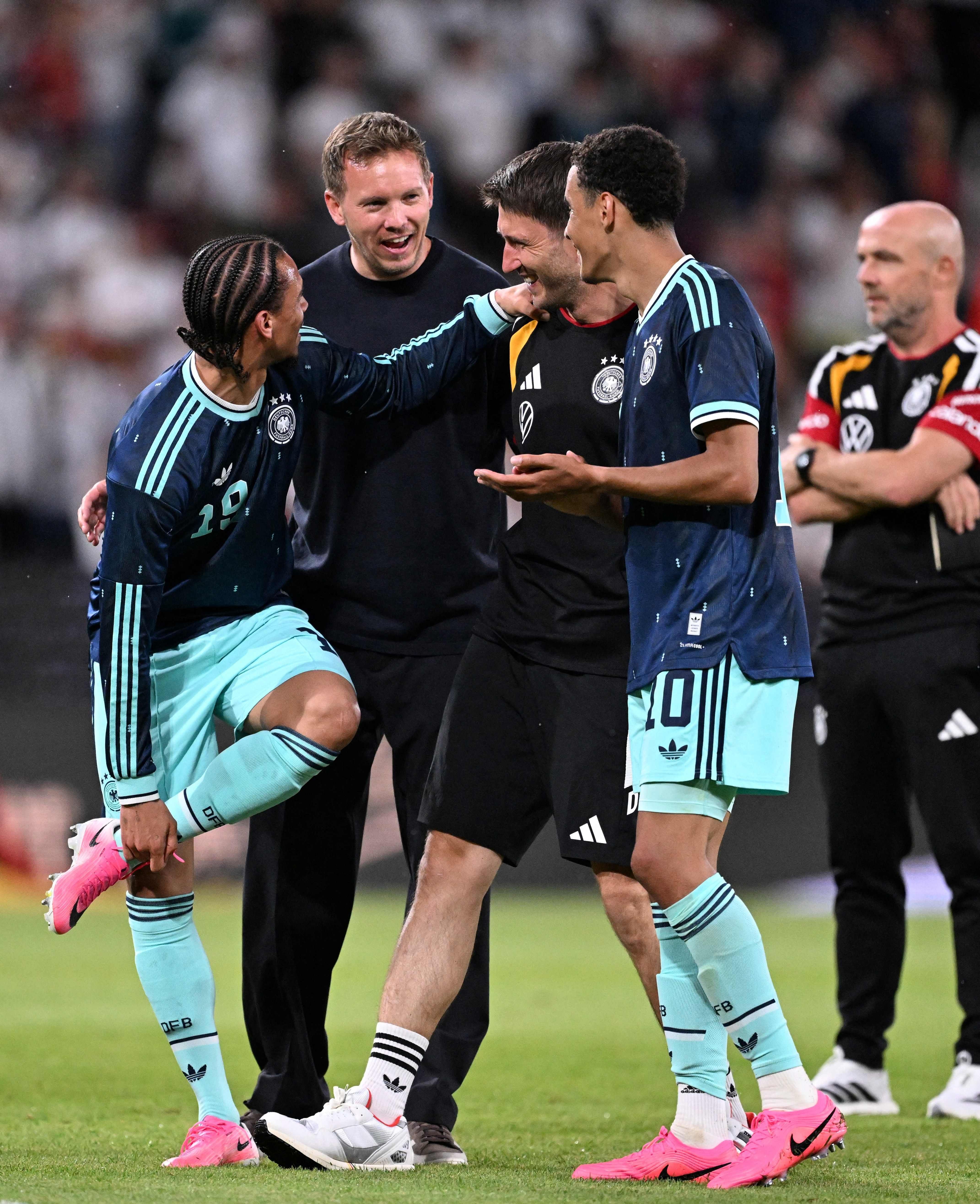 Germany's head coach Julian Nagelsmann (2L) celebrates with assistant coach Benjamin Glueck (2R) and Germany's midfielder #10 Jamal Musiala (R) and Germany's midfielder #19 Leroy Sane after their team won the friendly match between Germany and Finland ahead of the 2026 FIFA World Cup football tournament, in Mainz, western Germany on May 31, 2026. Germany won the match 4-0. (Photo by Kirill KUDRYAVTSEV / AFP)