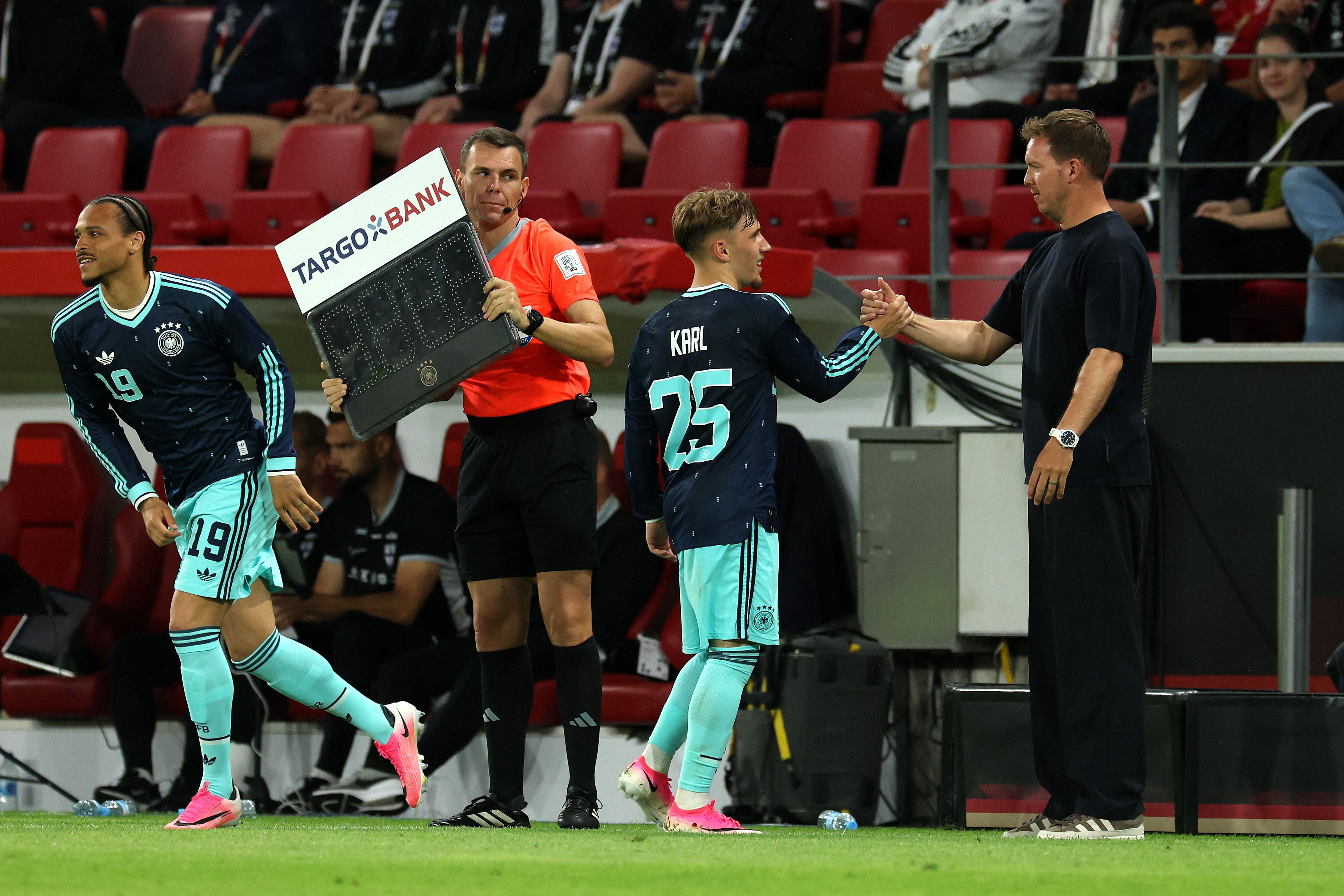 MAINZ, GERMANY - MAY 31: Lennart Karl of Germany is embraced by Julian Nagelsmann, Head Coach of Germany, after being substituted during the international friendly match between Germany and Finland at MEWA Arena on May 31, 2026 in Mainz, Germany. (Photo by Alexander Hassenstein/Getty Images)