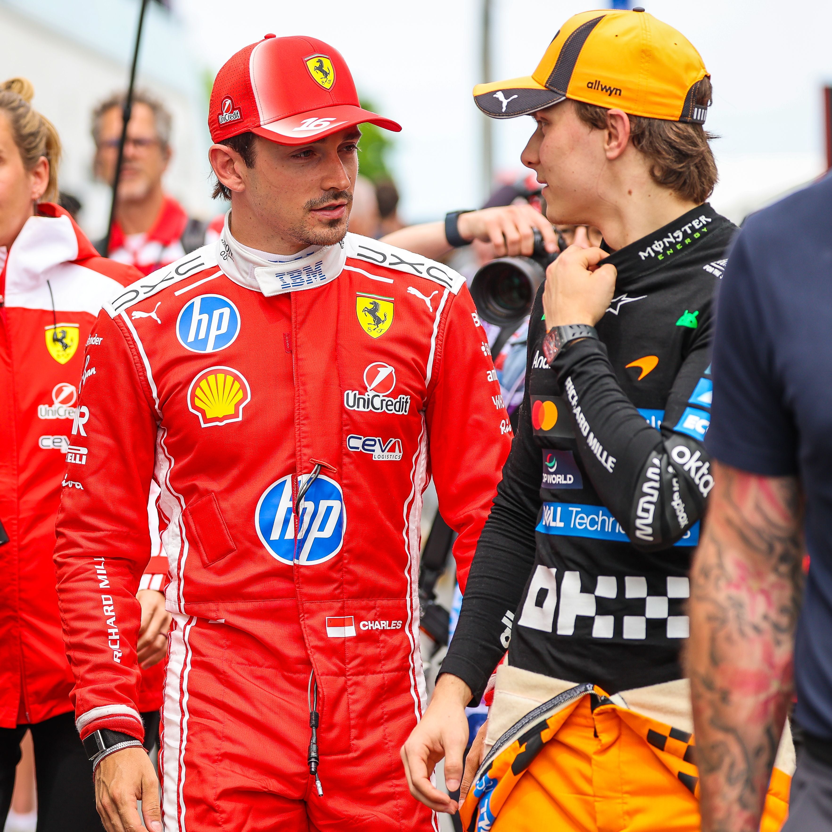 MONTREAL, CANADA - MAY 23: Charles Leclerc of Monaco and Scuderia Ferrari and Oscar Piastri of Australia and McLaren Mastercard F1 Team chat as they walk in the paddock during the Sprint Race ahead of the F1 Grand Prix of Canada at Circuit Gilles-Villeneuve on May 23, 2026 in Montreal, Canada. (Photo by Kym Illman/Getty Images)