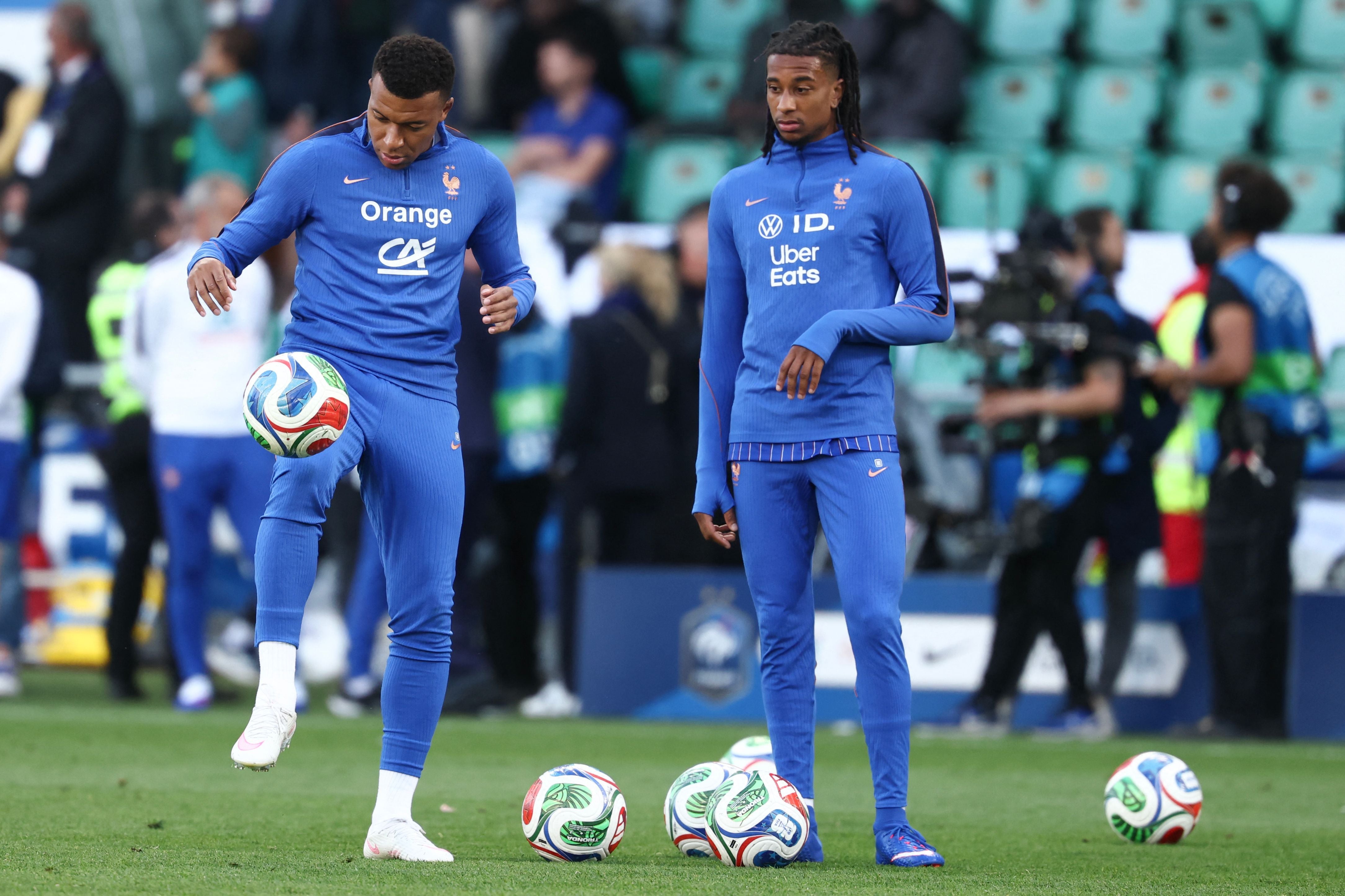 France's forward #10 Kylian Mbappe and France's forward #17 Michael Olise warm up before the international friendly football match between France and Ivory Coast ahead of the 2026 FIFA World Cup football tournament at the Stade de la Beaujoire in Nantes, western France, on June 4, 2026. (Photo by FRANCK FIFE / AFP)