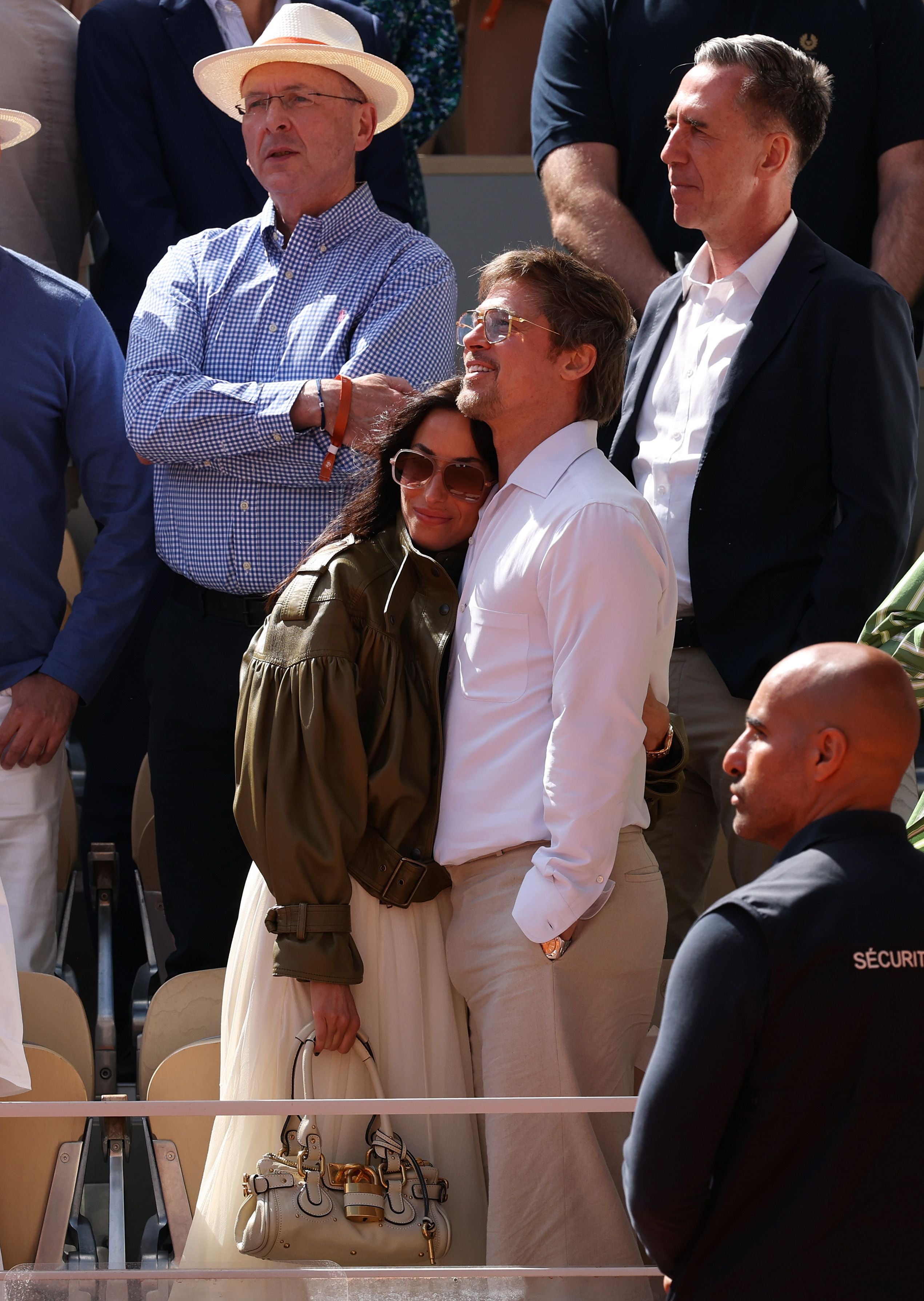 PARIS, FRANCE - JUNE 06: Brad Pitt, American actor and film producer, and partner, Ines de Ramon, American Jewellery designer, embrace following the Women's Singles final between Maja Chwalinska of Poland and Mirra Andreeva on Day Fourteen of the 2026 French Open at Roland Garros on June 06, 2026 in Paris, France. (Photo by Matthew Stockman/Getty Images)