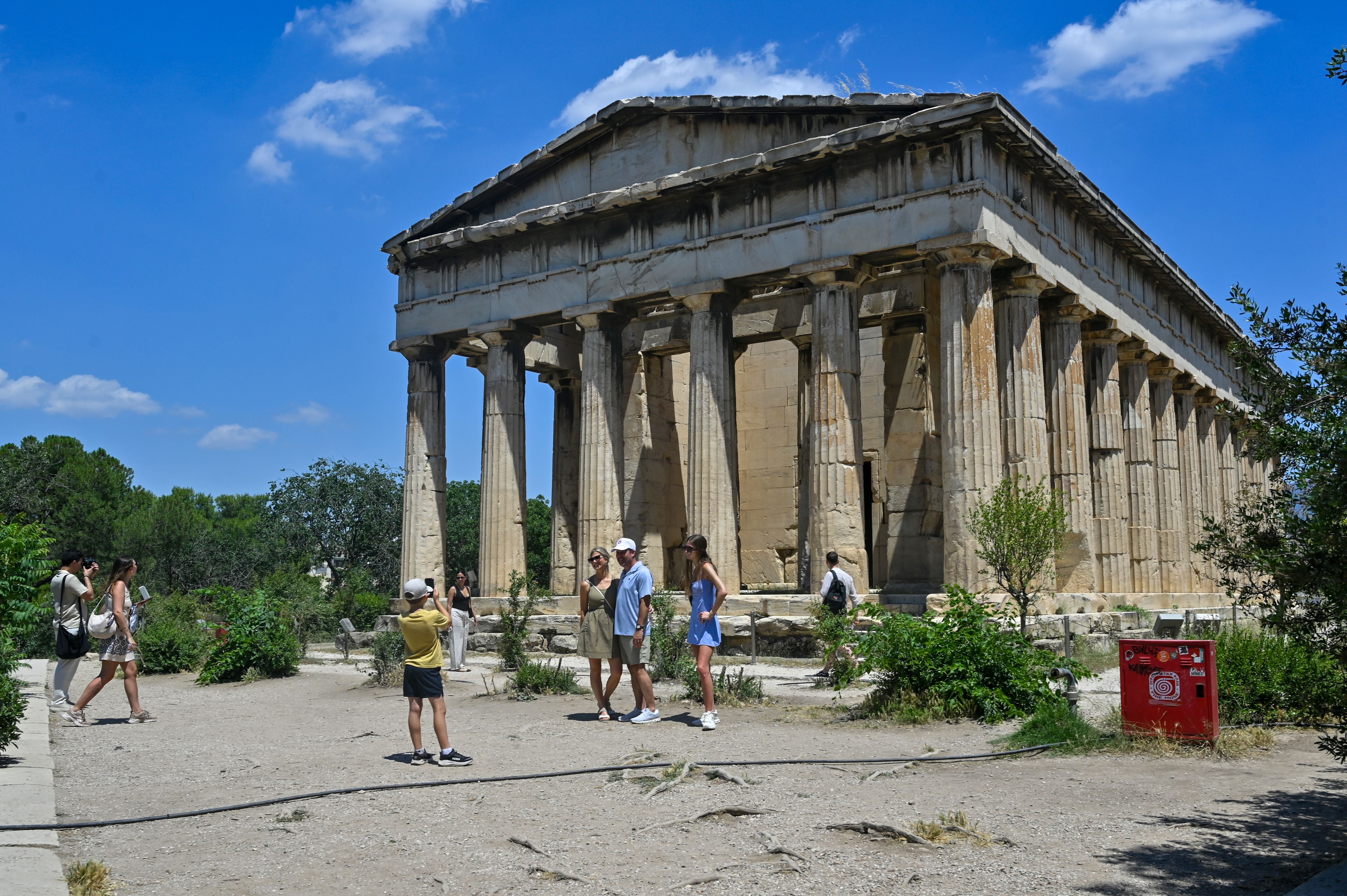 ATHENS, GREECE - JUN 6: Tourists make photos in front of Temple of Hephaestus at the Roman Agora archaeological site during a hot day on Jun 6, 2026 in Athens, Greece. (Photo by Milos Bicanski/Getty Images)