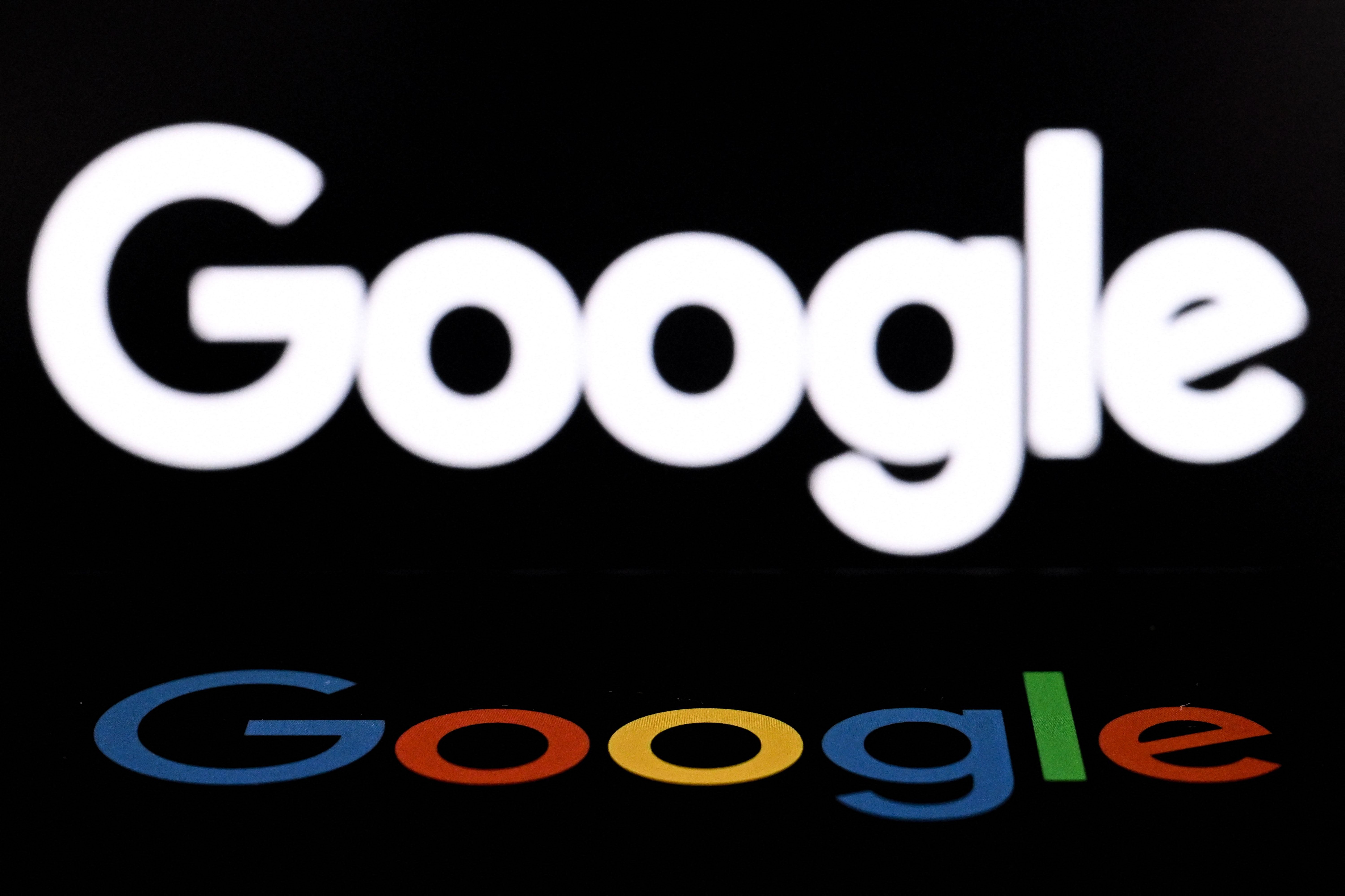 (FILES) A photo taken on May 19, 2026 shows the US multinational technology and Internet-related services company Google displayed on a smartphone (bottom) in front of the Google's logo on a laptop screen in Frankfurt am Main, western Germany. SpaceX on June 5, 2026 signed a blockbuster cloud computing agreement under which Google will pay the Elon Musk-founded rocket company $920 million per month for access to a massive cluster of AI chips, according to a disclosure in its initial public offering filing. (Photo by Kirill KUDRYAVTSEV / AFP)