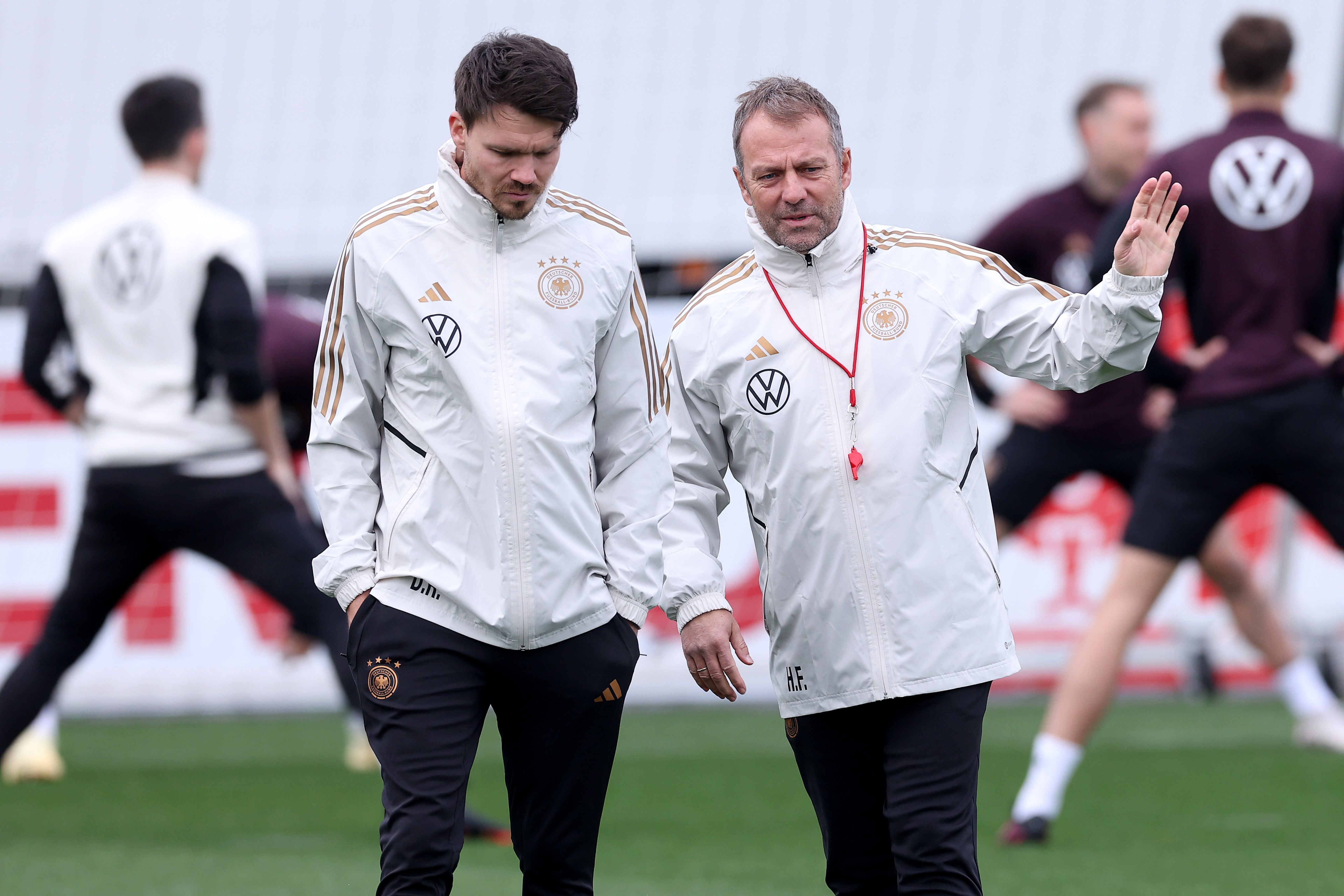FRANKFURT AM MAIN, GERMANY - MARCH 22: Hans-Dieter Flick, head coach of team Germany talks to his assistent coach Danny Röhl (L) of Germany during a training session of the German national team at DFB-Campus on March 22, 2023 in Frankfurt am Main, Germany. (Photo by Alexander Hassenstein/Getty Images)