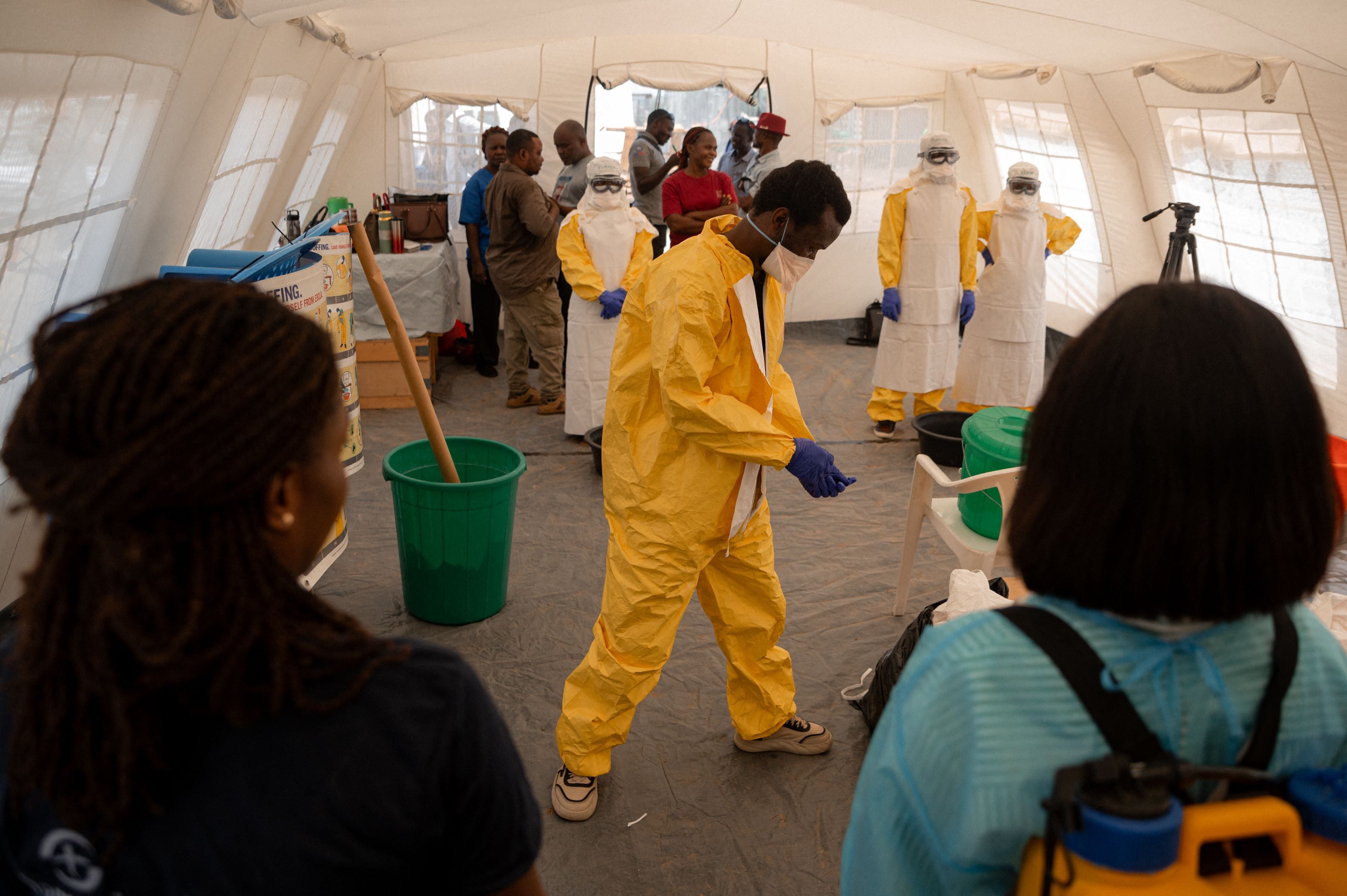 Local healthcare workers take part in an accelerated training session at the Scott Powell Memorial Ebola Treatment Center on the use of single-use personal protective equipment, including procedures for putting on and removing protective gear as well as safety measures required when caring for Ebola virus disease patients or during safe and dignified burial operations in Bunia, Democratic Republic of Congo, on June 11, 2026. Built by Samaritan's Purse International Relief, the centre was officially inaugurated in the presence of local authorities, humanitarian partners and health sector stakeholders to strengthen patient care and the response to Ebola virus disease. (Photo by Jospin Mwisha / AFP)