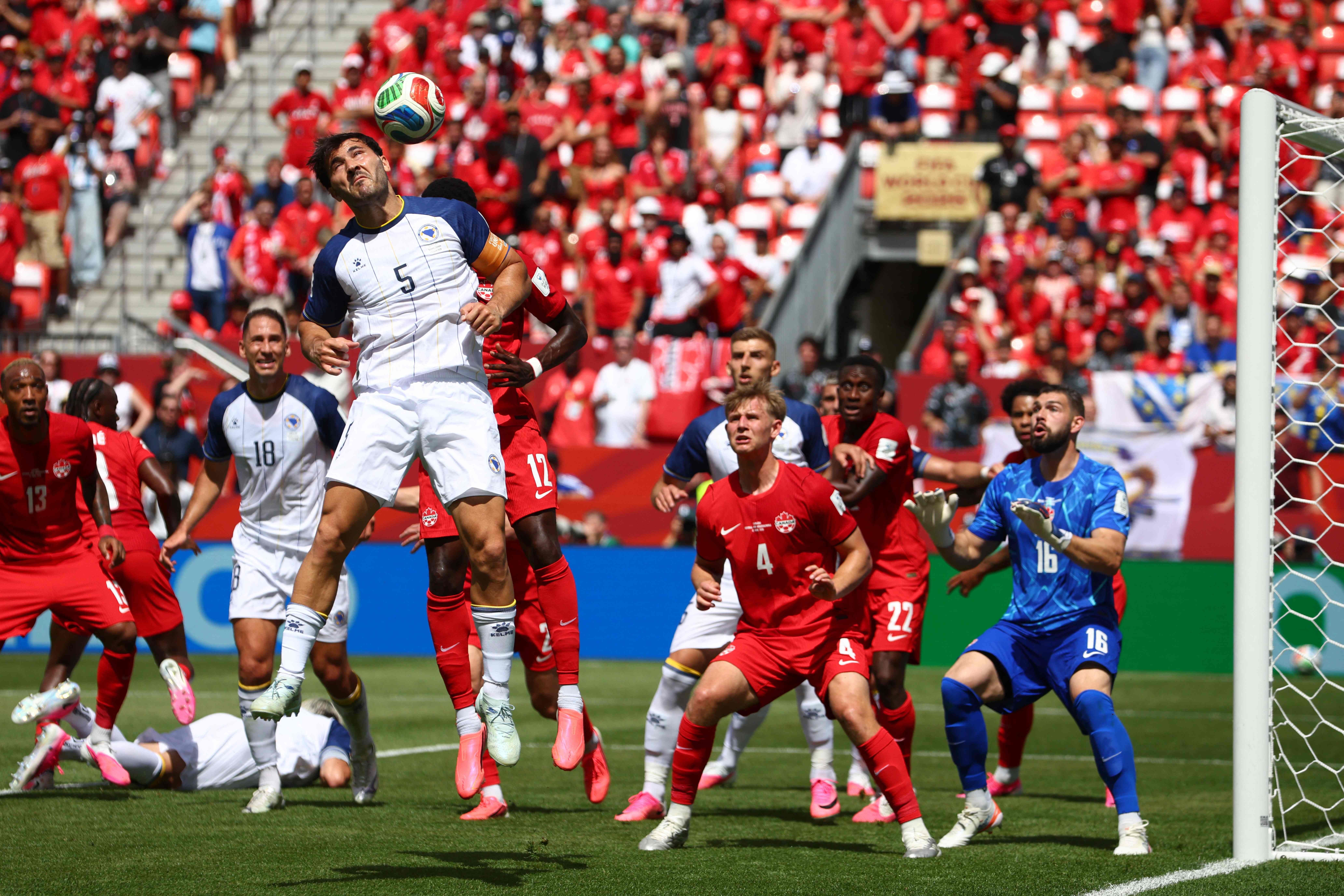 Bosnia-Herzegovina's defender #05 Sead Kolasinac heads the ball during the 2026 World Cup Group B football match between Canada and Bosnia and Herzegovina at the Toronto Stadium in Toronto on June 12, 2026. (Photo by Cole Burston / AFP)
