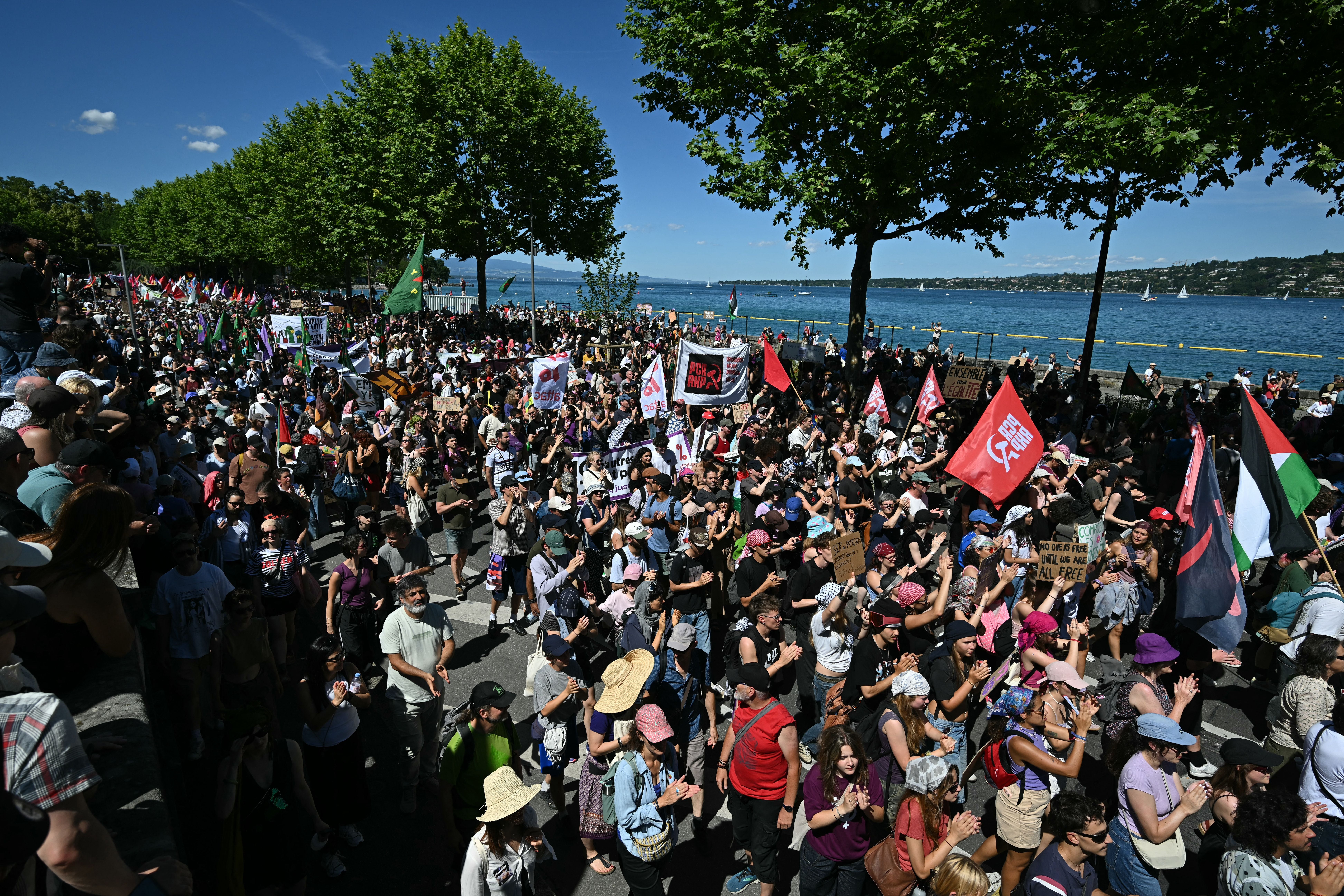 Demonstrators take part in a rally of a 'No-G7' coalition of over 60 associations, unions and left-wing groups 'against fascism and imperialism”, a day ahead of the summit's start, in Geneva on June 14, 2026. The 2026 edition of the G7 summit is set to take place June 15 to 17 in the French town of Evian-les-Bains near Switzerland, attended by country leaders as well as the EU's foreign policy chief and ministers from Brazil, Canada, the United Arab Emirates and Turkey. (Photo by Fabrice COFFRINI / AFP)