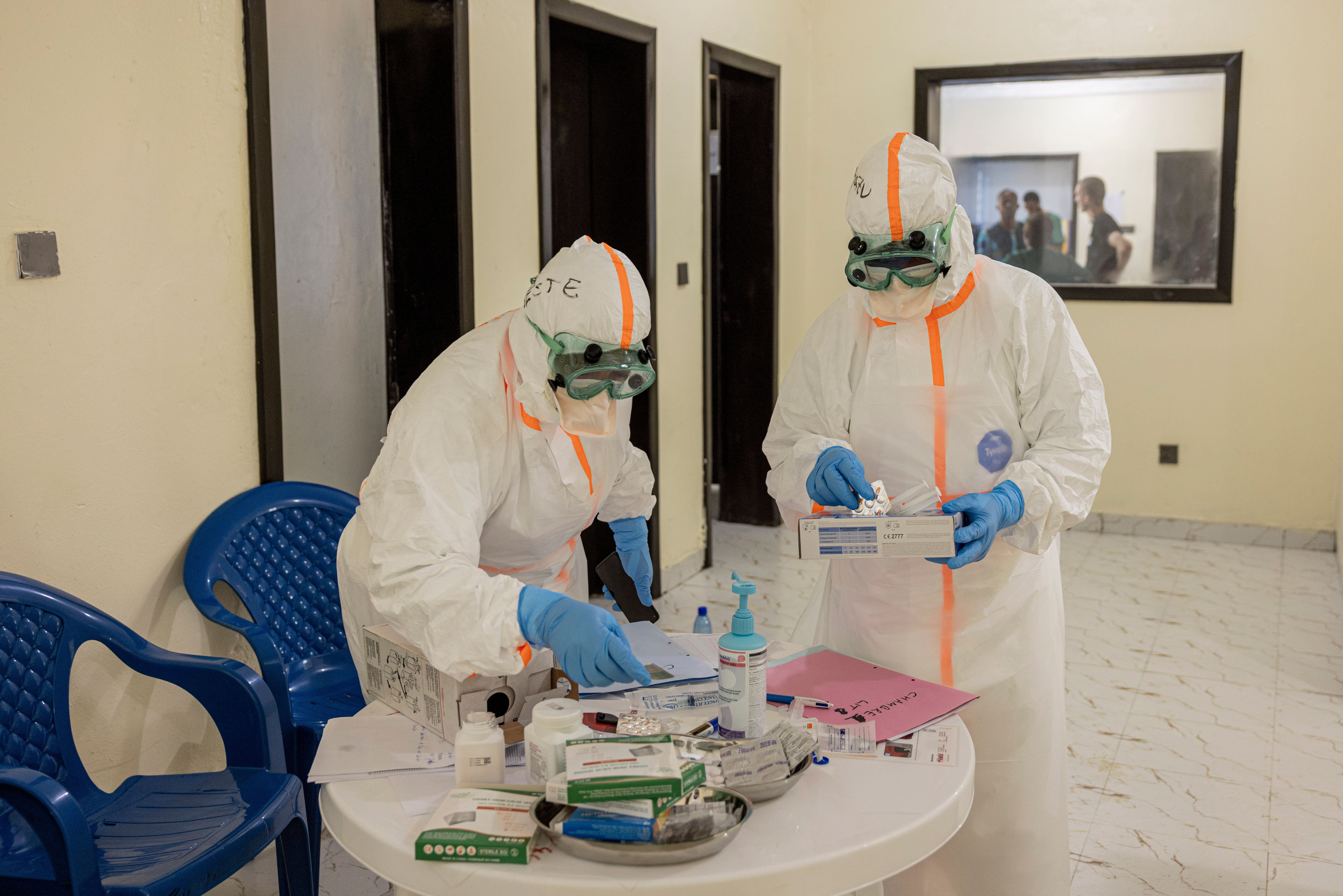 BUNIA, DEMOCRATIC REPUBLIC OF CONGO - JUNE 4: Medical staff wearing personal protective equipment (PPE) at the Evangelical Medical Institute on June 4, 2026 in Bunia, Democratic Republic of Congo. The World Health Organization (WHO) and the Africa Centres for Disease Control and Prevention (Africa CDC) are deploying rapid response teams to reinforce infection prevention protocols and safe burial practices. However, aid cuts have weakened frontline preparedness, and transmission is currently outpacing field containment capabilities. The current Ebola epidemic in the DRC is caused by the Bundibugyo virus for which there are no approved vaccines. The highest number of cases have been reported in Congo's eastern Ituri province, bordering Uganda. Global health officials have expressed grave concern over the capacity to contain the outbreak in a region already facing a humanitarian crisis, with highly mobile populations displaced by conflict and economic factors. (Photo by Michel Lunanga/Getty Images)