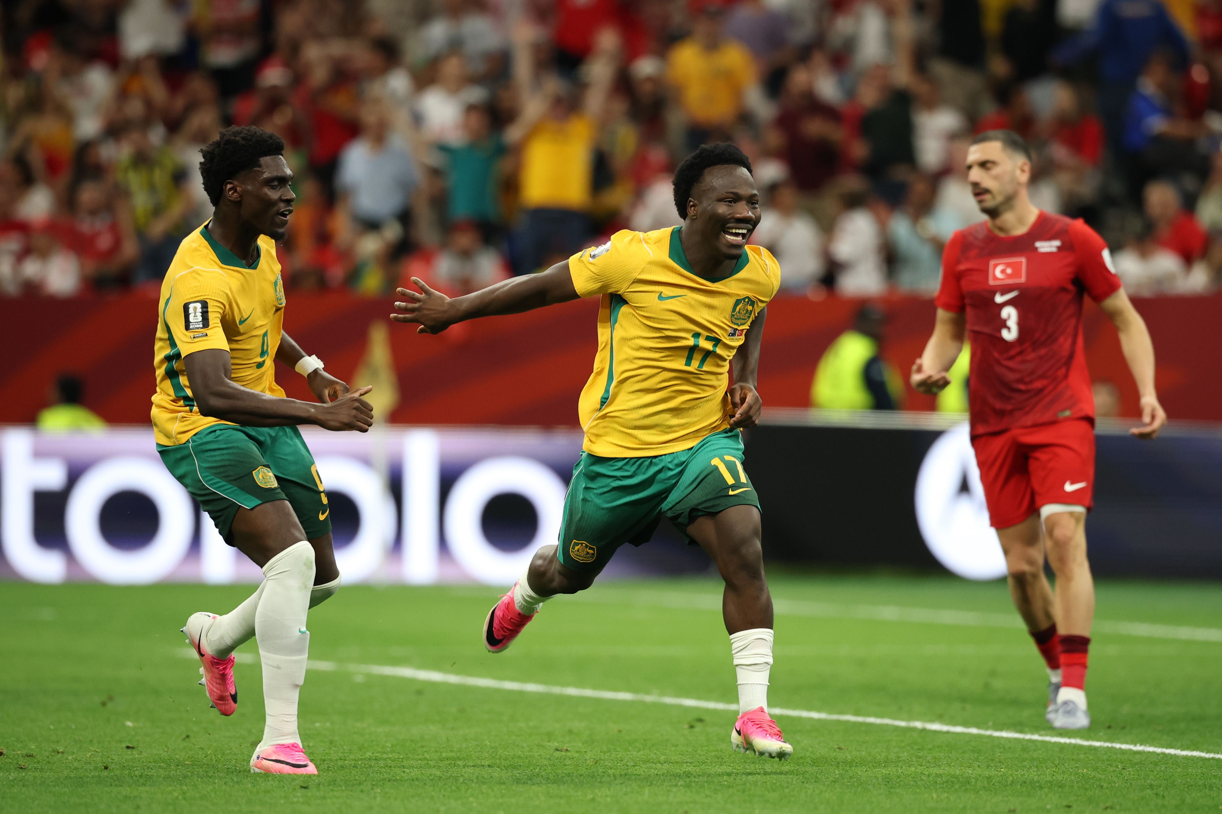 VANCOUVER, BRITISH COLUMBIA - JUNE 13: Nestory Irankunda #17 of Australia celebrates scoring his team's first goal with teammate Mohamed Toure #9 during the FIFA World Cup 2026 Group D match between Australia and Türkiye at BC Place Vancouver on June 13, 2026 in Vancouver, British Columbia. (Photo by Jared C. Tilton - FIFA/FIFA via Getty Images)