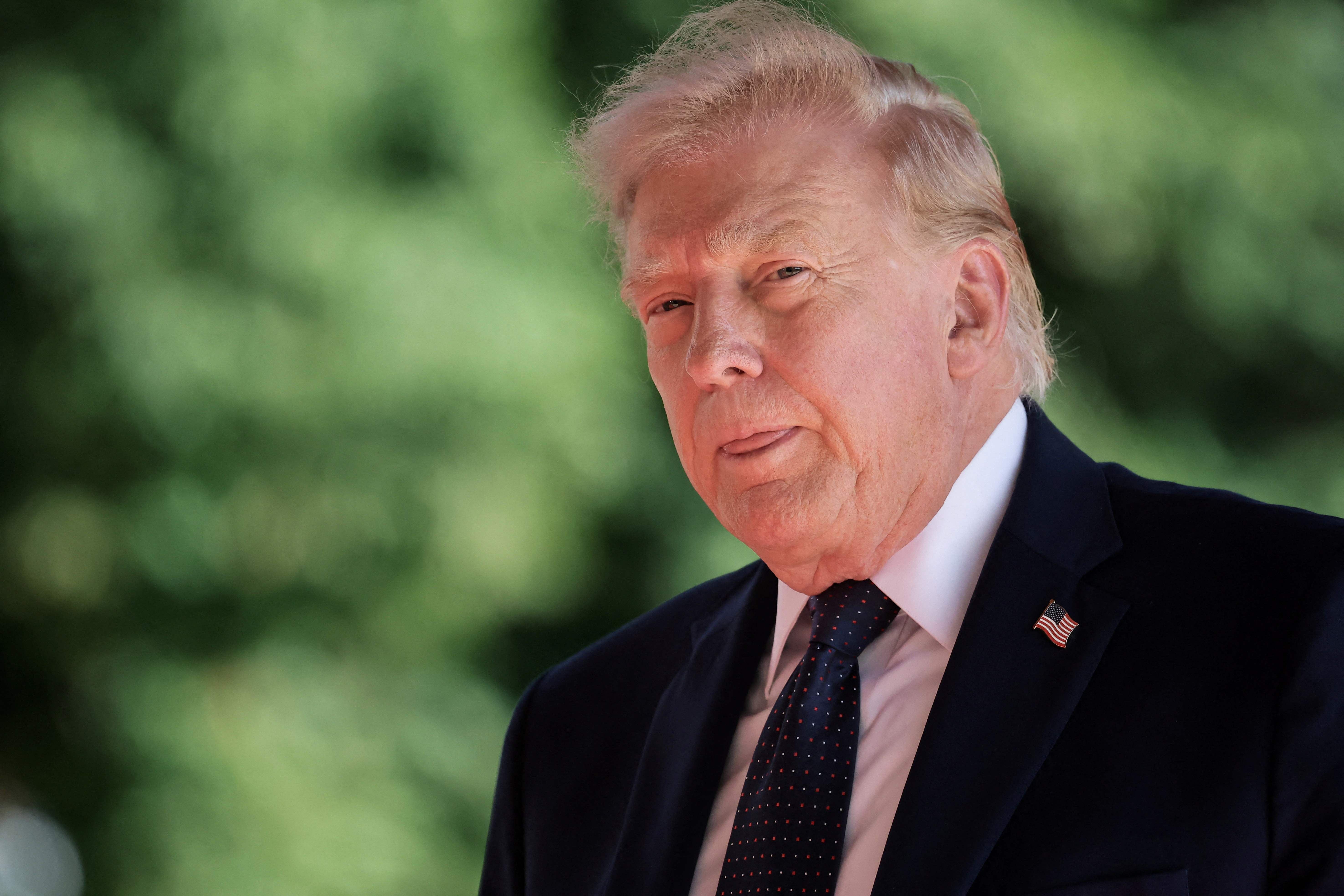 TOPSHOT - US President Donald Trump arrives for the G7 summit, in Evian, eastern France, on June 15, 2026. A G7 summit is set to take place June 15 to 17 in the French town of Evian-les-Bains near Switzerland and it will be attended by country leaders as well as the EU's foreign policy chief and ministers from Brazil, Canada, the United Arab Emirates and Turkey. (Photo by Christian Hartmann / POOL / AFP)