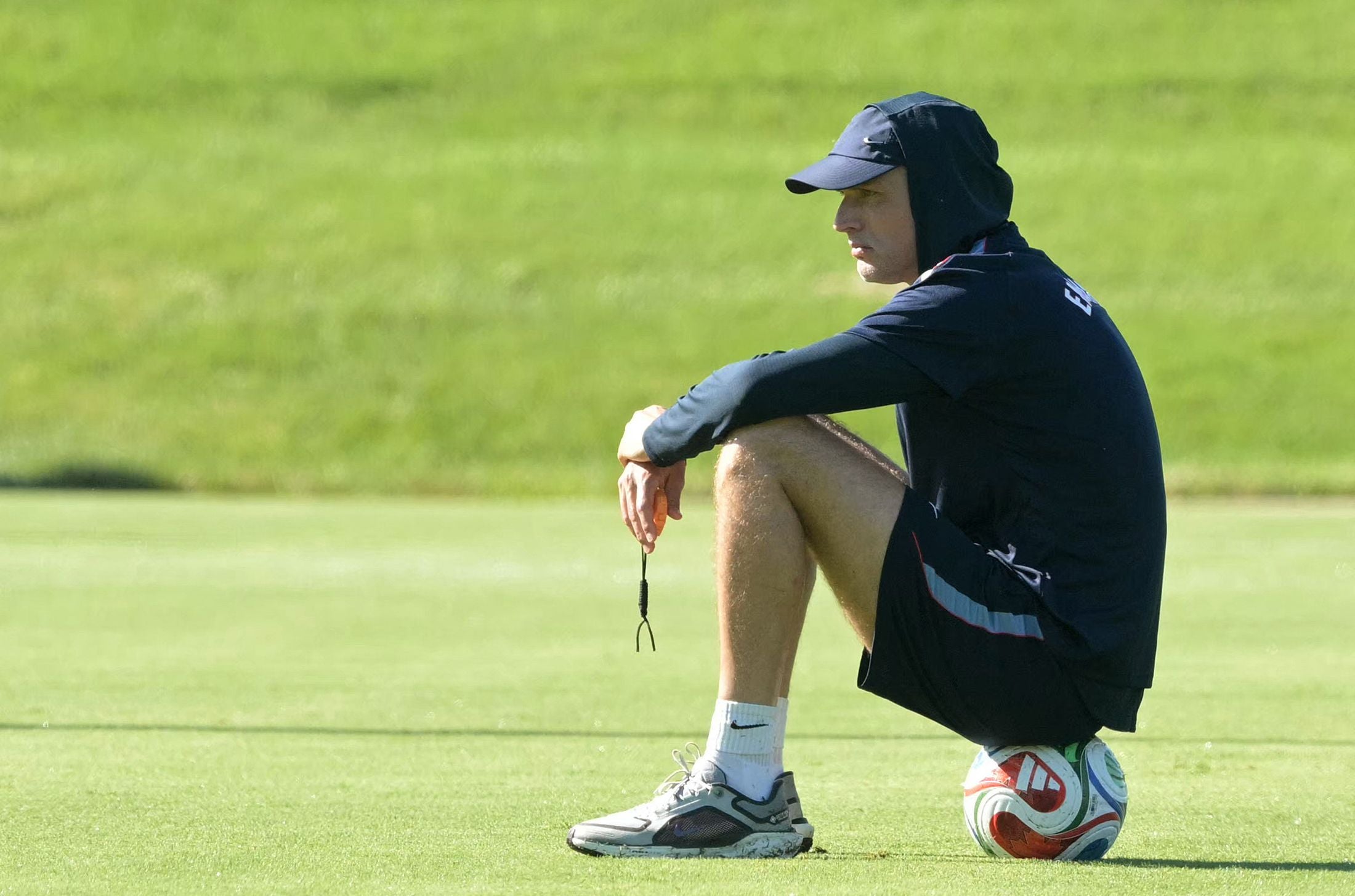 England's German head coach Thomas Tuchel sits on a ball during a training session ahead of England's 2026 World Cup football tournament Group L football match against Croatia at Swope Soccer Village in Kansas City on June 13, 2026. (Photo by JUAN MABROMATA / AFP)