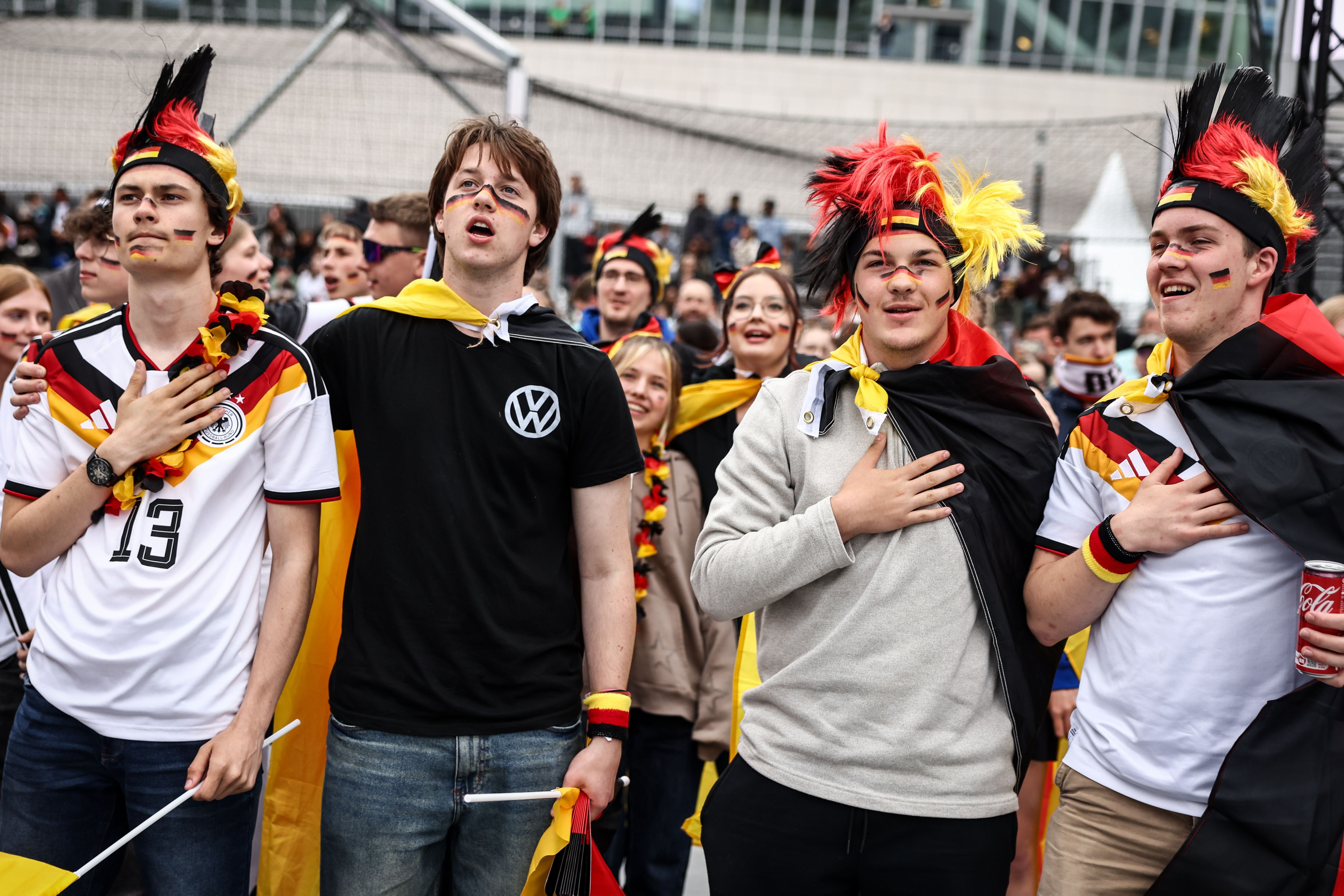 BERLIN, GERMANY - JUNE 14: Football fans sing the German national hymn before the Germany vs. Curacao Group E match of the FIFA World Cup 2026 at a public viewing square on June 14, 2026 in Berlin, Germany. Today's match is Germany's first in the 2026 World Cup. (Photo by Nadja Wohlleben/Getty Images)