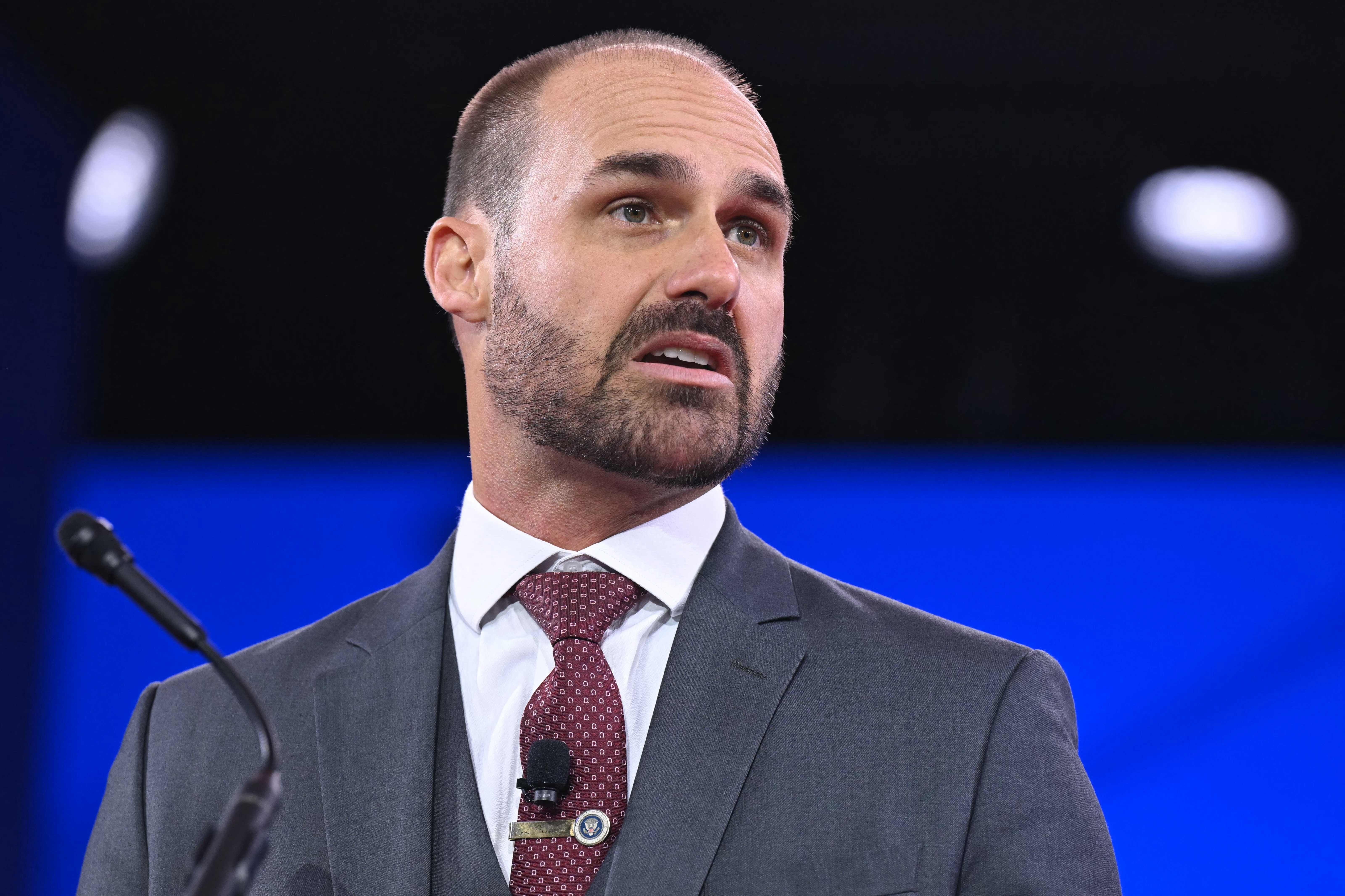 (FILES) Brazilian politician Eduardo Bolsonaro, son of Jair Bolsonaro, speaks during the annual Conservative Political Action Conference (CPAC) at the Gaylord National Resort &amp; Convention Center at National Harbor in Oxon Hill, Maryland, on February 20, 2025. Brazil's Supreme Court on June 16, 2026 convicted former lawmaker Eduardo Bolsonaro over alleged attempts to push for US sanctions to interfere in the trial on coup-plotting charges against his father, former president Jair Bolsonaro. (Photo by SAUL LOEB / AFP)
