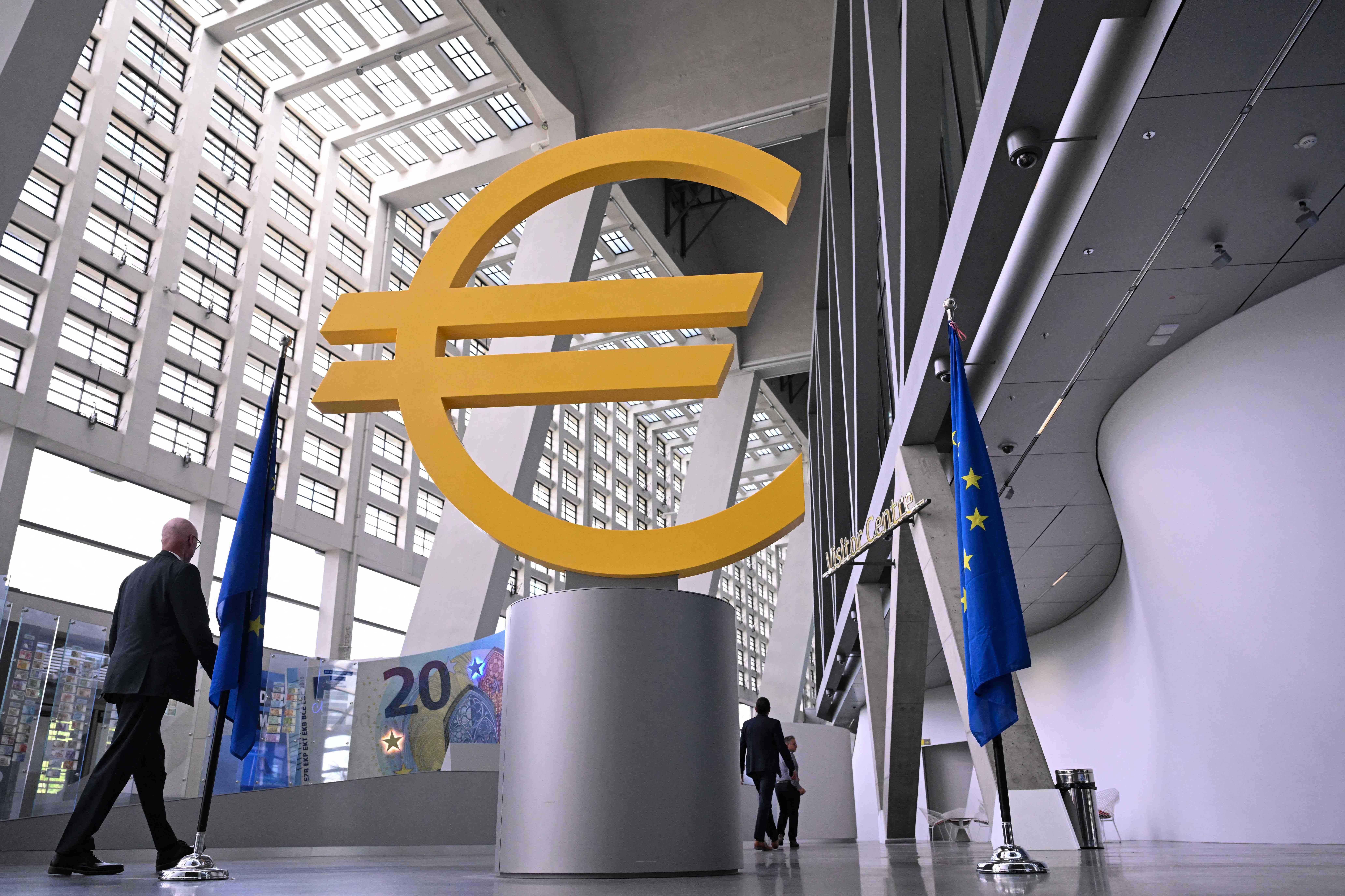 A visitor walks past a giant Euro sign inside the headquarters of the European Central Bank (ECB) in Frankfurt am Main, western Germany, on June 11, 2026, ahead of the bank's meeting on the Eurozone's monetary policy. The European Central Bank is set to hike interest rates on June 11 for the first time since 2023 as the Iran war fuels inflation, despite concerns the move could hit growth in the struggling eurozone. (Photo by Kirill KUDRYAVTSEV / AFP)