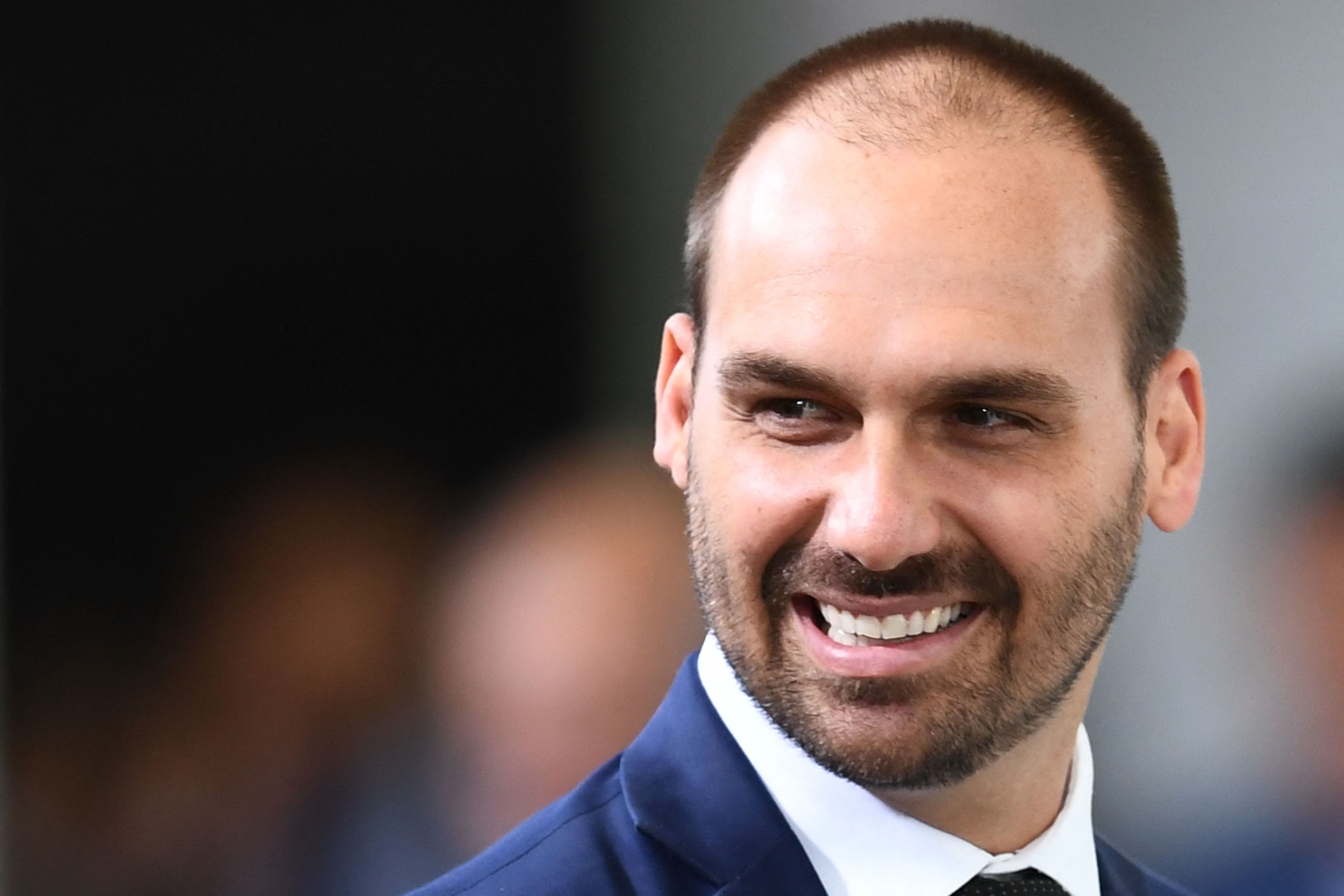 (FILES) Deputy Eduardo Bolsonaro, son of Brazilian President Jair Bolsonaro, attend the launching ceremony of the Front Brazil Project, which aims at reducing the rates of violence in cities, at Planalto Palace in Brasilia, on August 29, 2019. Brazil's Supreme Court on June 16, 2026 convicted former lawmaker Eduardo Bolsonaro over alleged attempts to push for US sanctions to interfere in the trial on coup-plotting charges against his father, former president Jair Bolsonaro. (Photo by EVARISTO SA / AFP)