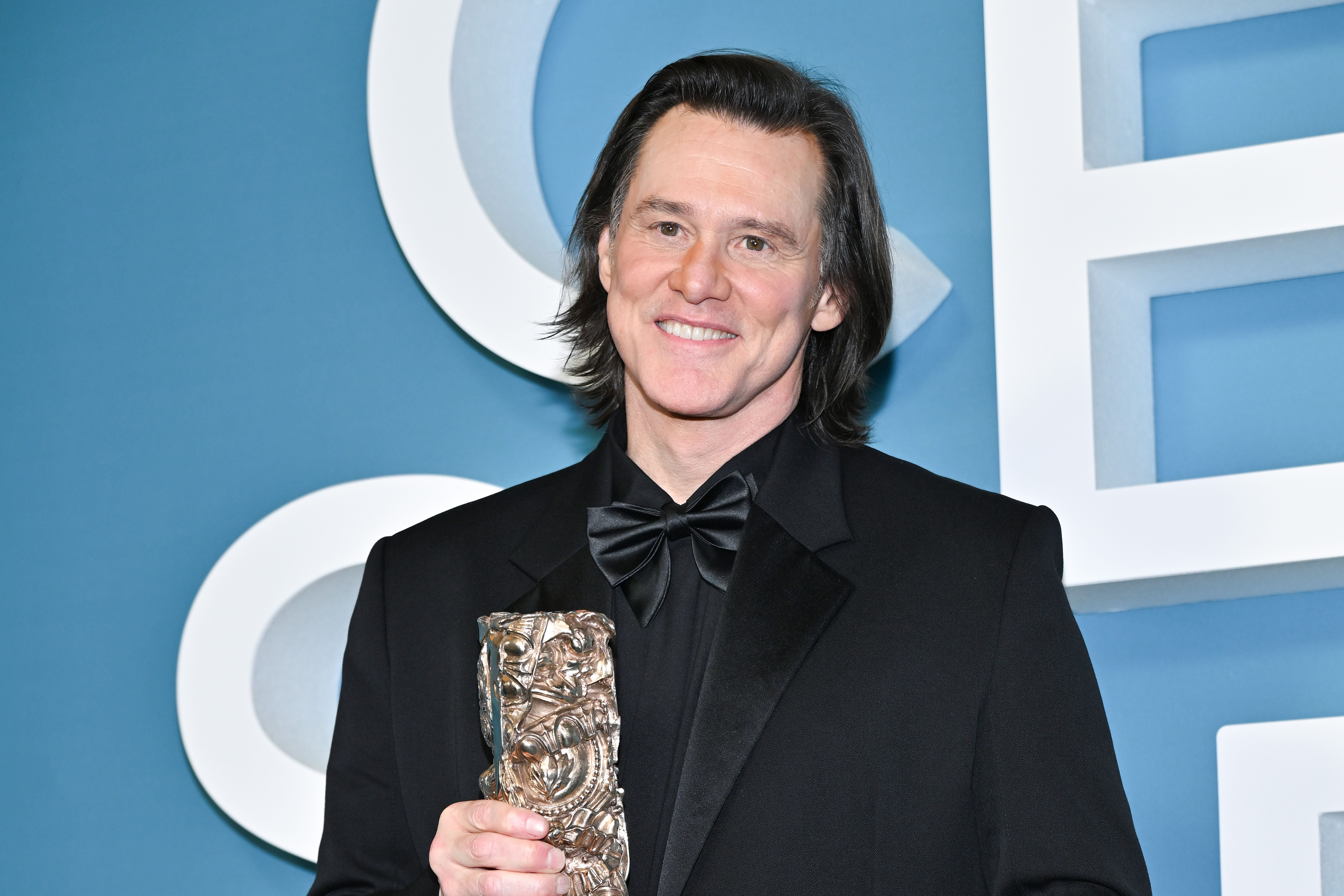PARIS, FRANCE - FEBRUARY 26: Jim Carrey poses in the winners room with the "Honorary" Award during the 51st Cesar Film Awards at L'Olympia on February 26, 2026 in Paris, France. (Photo by Dominique Charriau/WireImage)