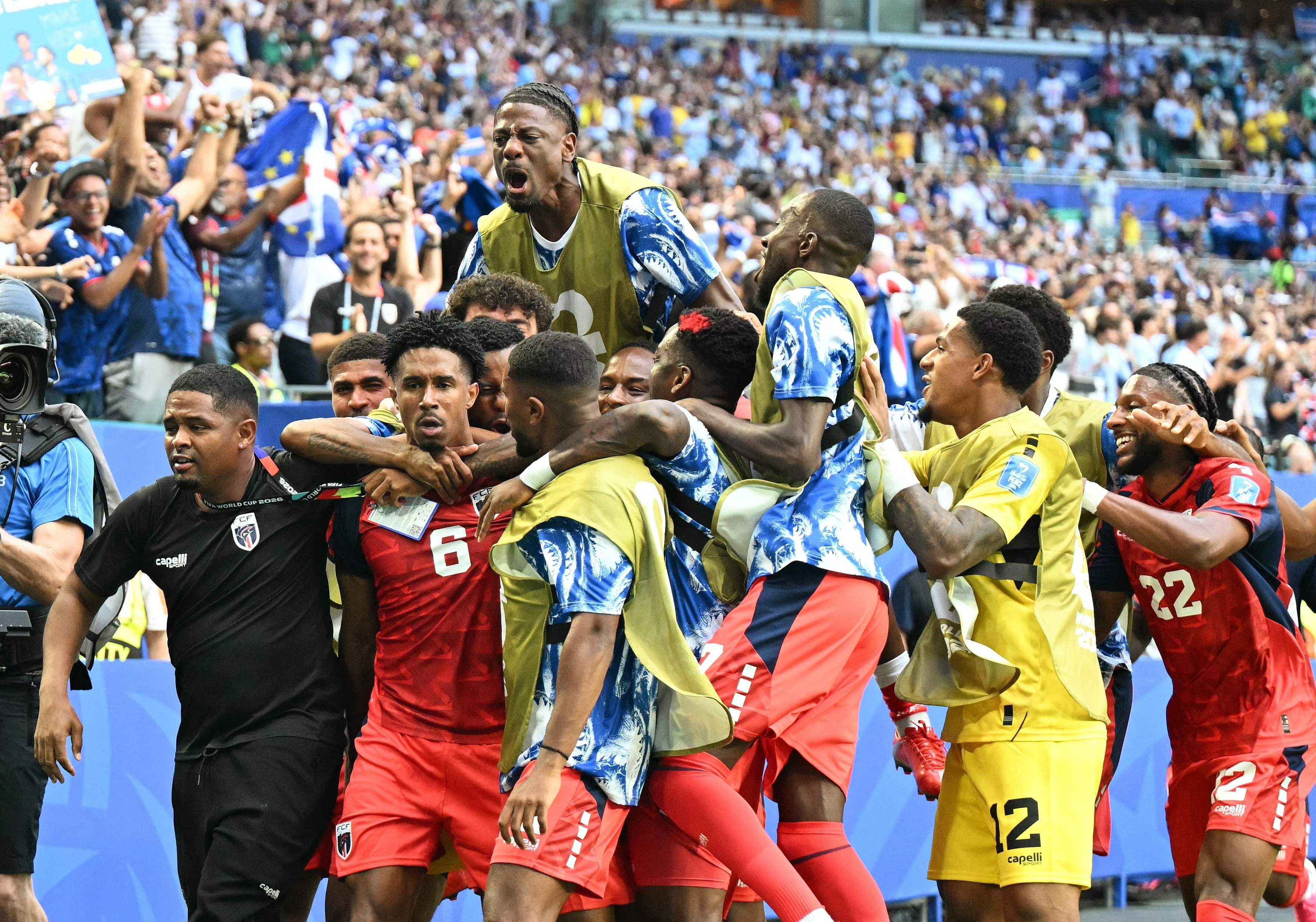 Cape Verde's midfielder #06 Kevin Pina celebrates with teammates after scoring his team's first goal during the 2026 World Cup Group H football match between Uruguay and Cape Verde at the Miami Stadium in Miami Gardens on June 21, 2026. (Photo by CHANDAN KHANNA / AFP)