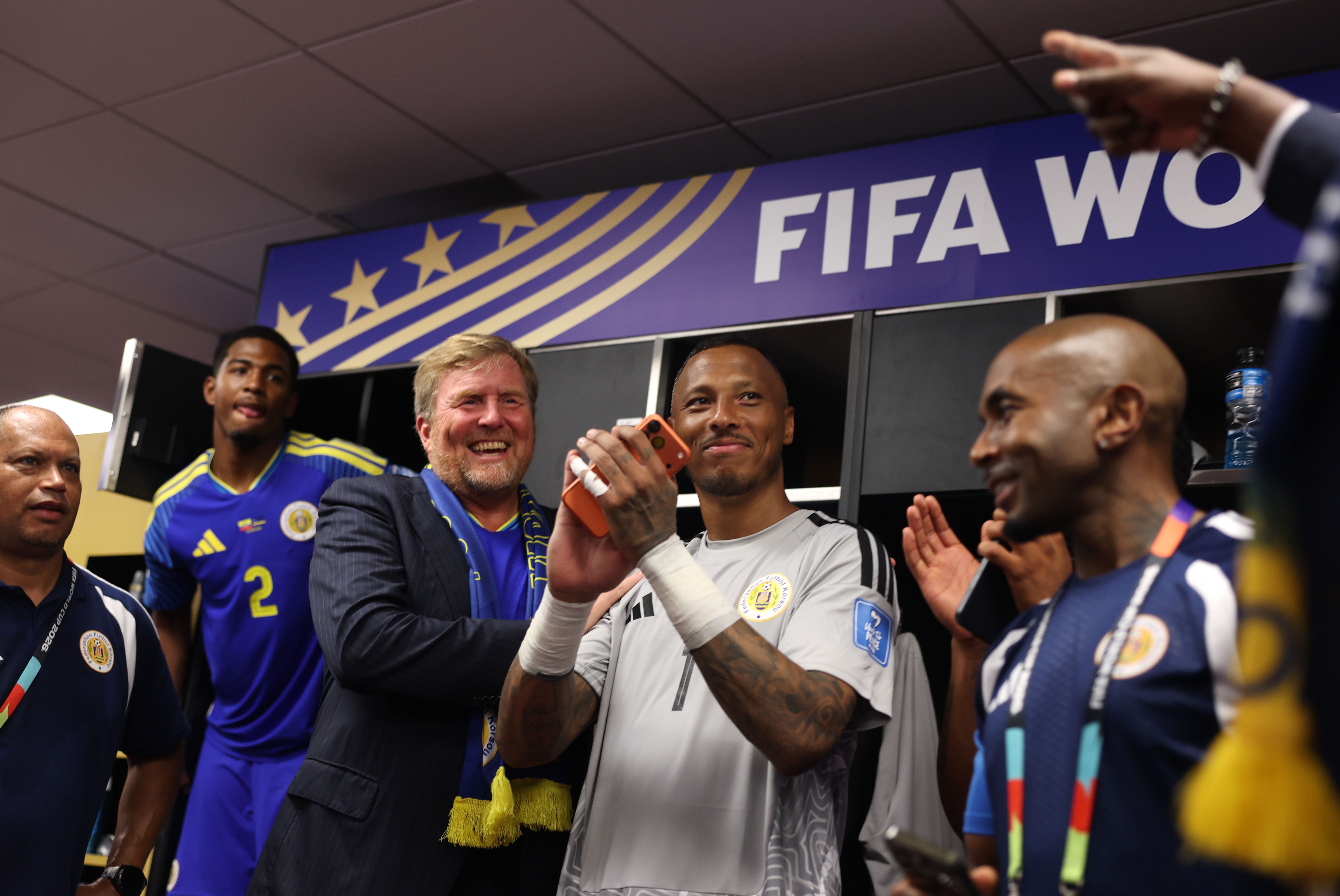 KANSAS CITY, MISSOURI - JUNE 20: King Willem-Alexander of the Netherlands interacts with Eloy Room #1 of Curacao and his teammates in the dressing room after the 0-0 draw during the FIFA World Cup 2026 Group E match between Ecuador and Curacao at Kansas City Stadium on June 20, 2026 in Kansas City, Missouri. (Photo by Alex Pantling - FIFA/FIFA via Getty Images)