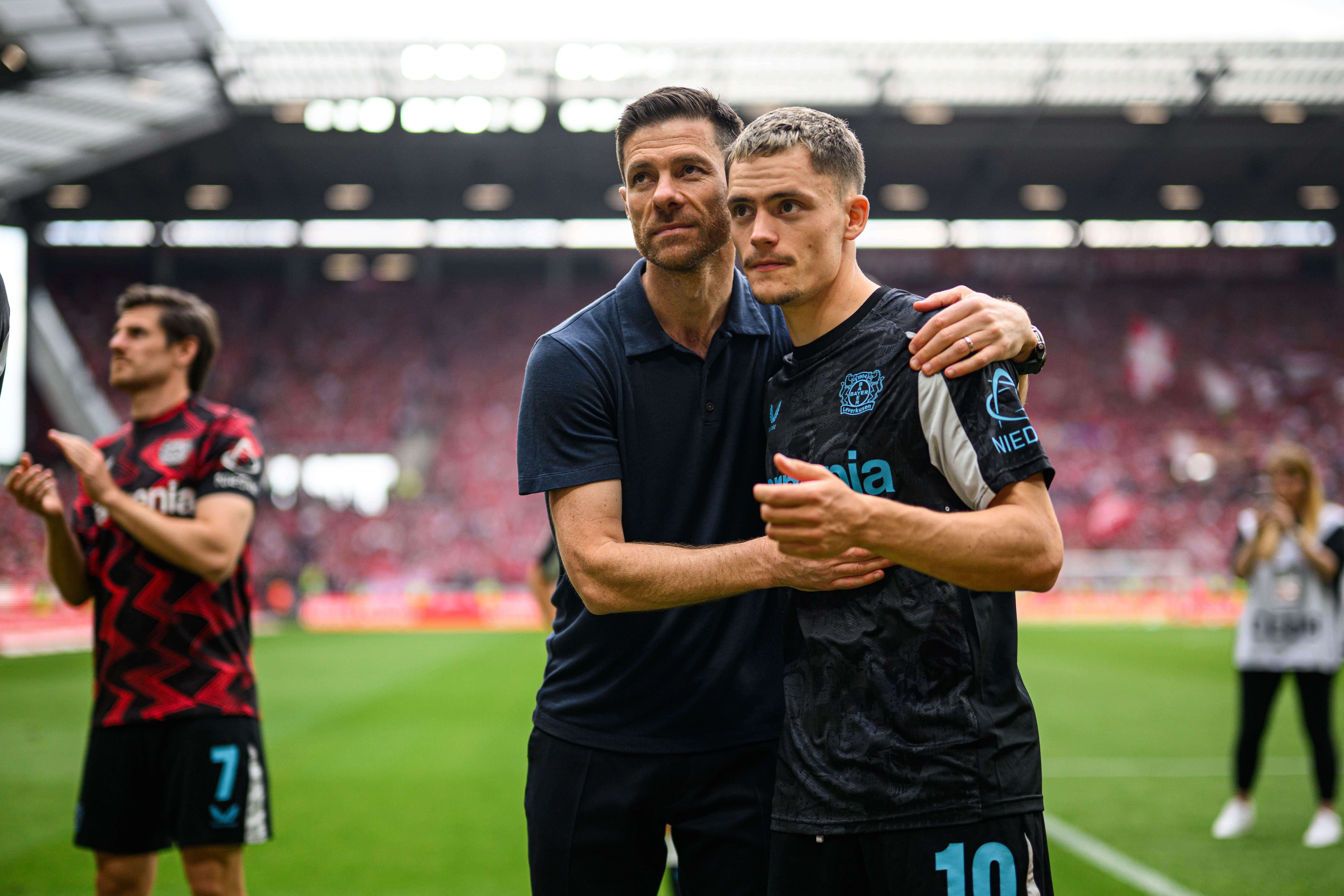 MAINZ, GERMANY - MAY 17: Head coach Xabi Alonso of Leverkusen gives Florian Wirtzi a hug after the Bundesliga match between 1. FSV Mainz 05 and Bayer 04 Leverkusen at MEWA Arena on May 17, 2025 in Mainz, Germany. (Photo by Jörg Schüler/Bayer 04 Leverkusen via Getty Images)