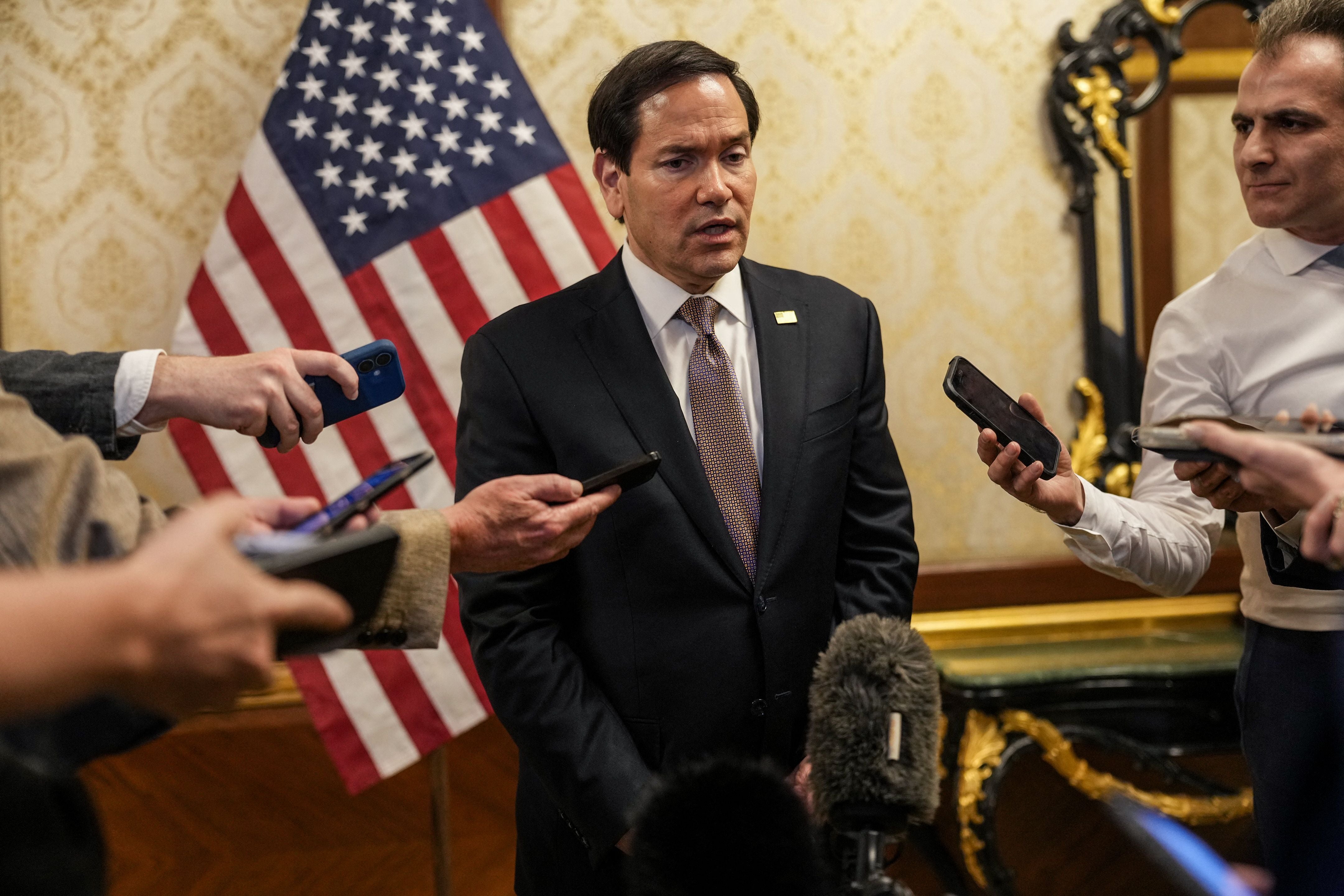 US Secretary of State Marco Rubio speaks to members of the media before boarding a US Air Force C-17 Globemaster III transport aircraft en route to Bahrain at Kuwait International Airport during his visit to the Middle East to discuss the interim deal between the US and Iran with Arab Gulf allies, in Kuwait City, on June 24, 2026. Rubio held talks with Kuwait's leader on June 24, after renewing Washington's commitment to the region's security in a meeting with the UAE's president during a tour of the Gulf. (Photo by Eric Lee / POOL / AFP)