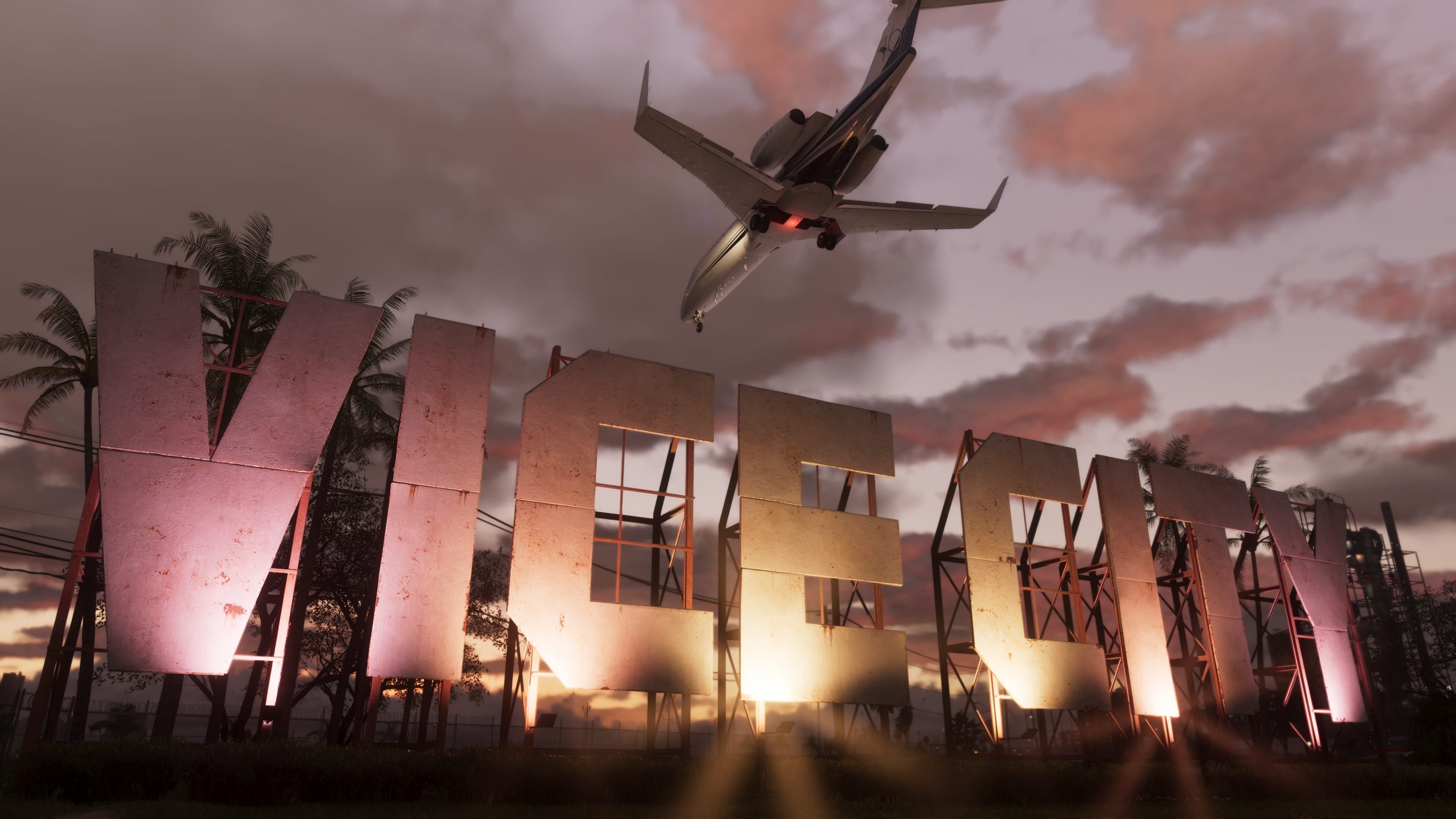 Ein Flugzeug fliegt über ein großes, beleuchtetes "VICE CITY"-Schild bei Sonnenuntergang.