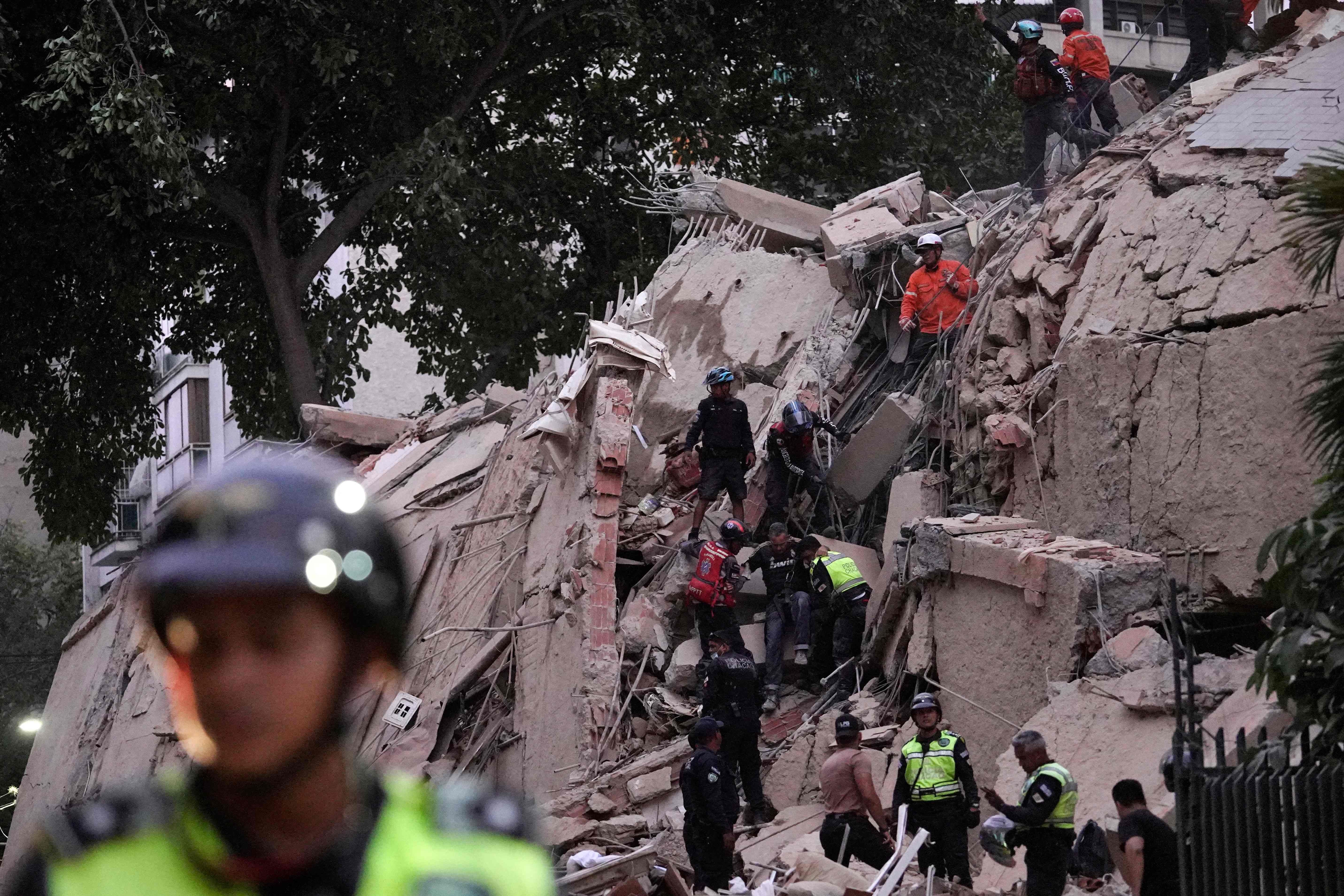 Rescue workers evacuate an injured person from a collapsed building following an earthquake in Caracas on June 24, 2026. A magnitude 7.1 earthquake struck Venezuela on Wednesday, the United States Geological Survey (USGS) reported, triggering panic in Caracas, according to AFP journalists. The tremor, which was followed by several aftershocks, was also felt in Colombia. (Photo by Manaure Quintero / AFP)