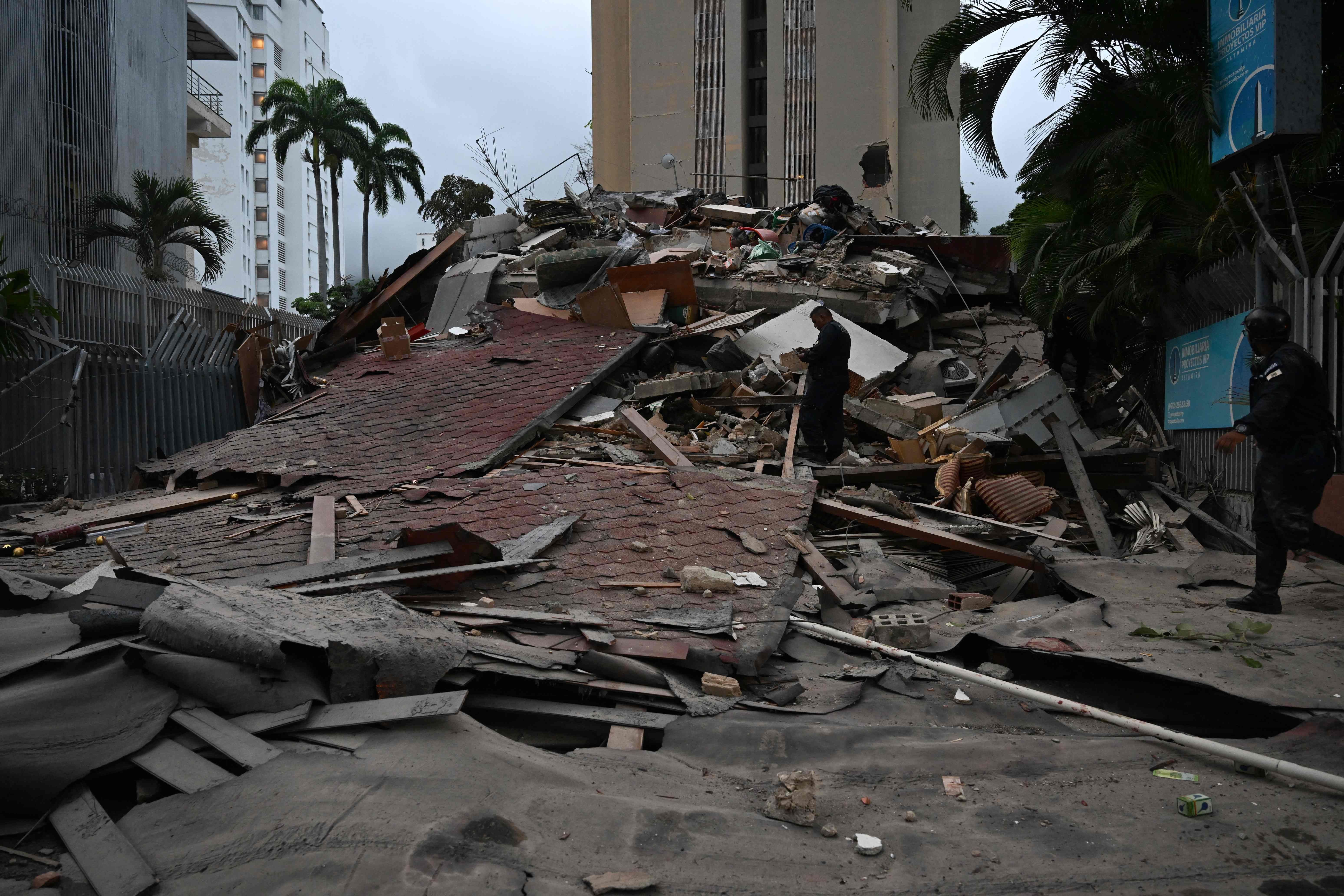 A collapsed building is seen following an earthquake in Caracas on June 24, 2026. A magnitude 7.1 earthquake struck Venezuela on Wednesday, the United States Geological Survey (USGS) reported, triggering panic in Caracas, according to AFP journalists. The tremor, which was followed by several aftershocks, was also felt in Colombia. (Photo by Juan BARRETO / AFP)