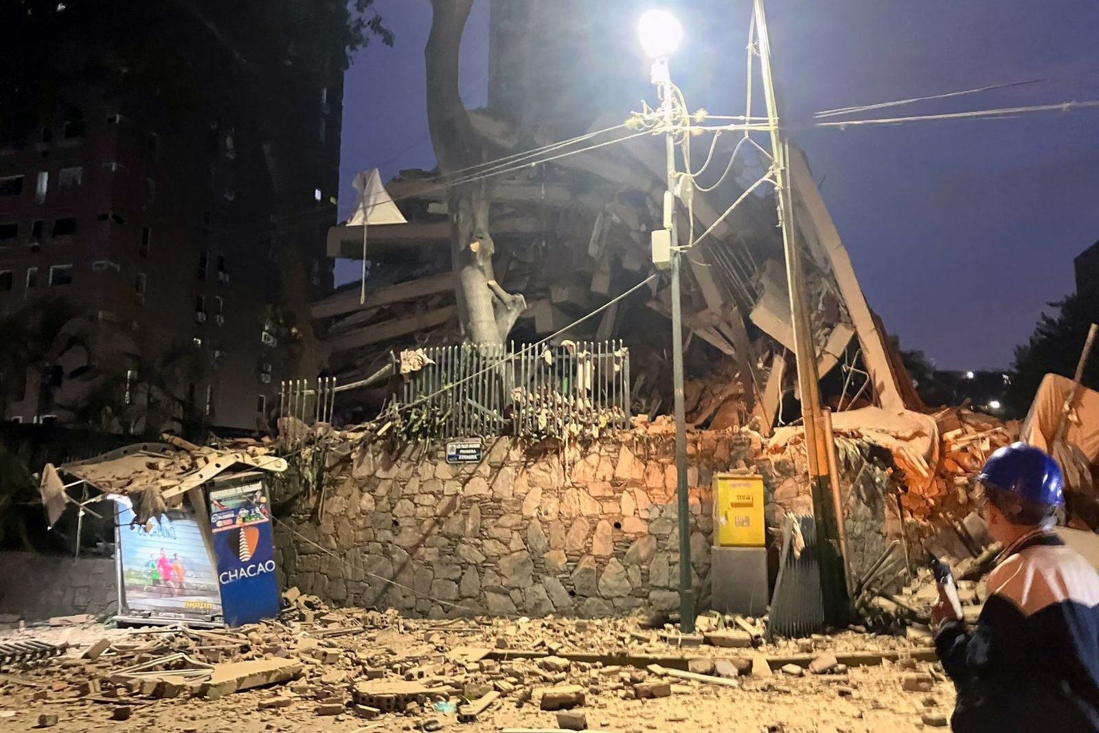 View of a collapsed building following an earthquake in Caracas on June 24, 2026. A magnitude 7.1 earthquake struck Venezuela on Wednesday, the United States Geological Survey (USGS) reported, triggering panic in Caracas, according to AFP journalists. The tremor, which was followed by several aftershocks, was also felt in Colombia. (Photo by Leticia PINEDA / AFP)