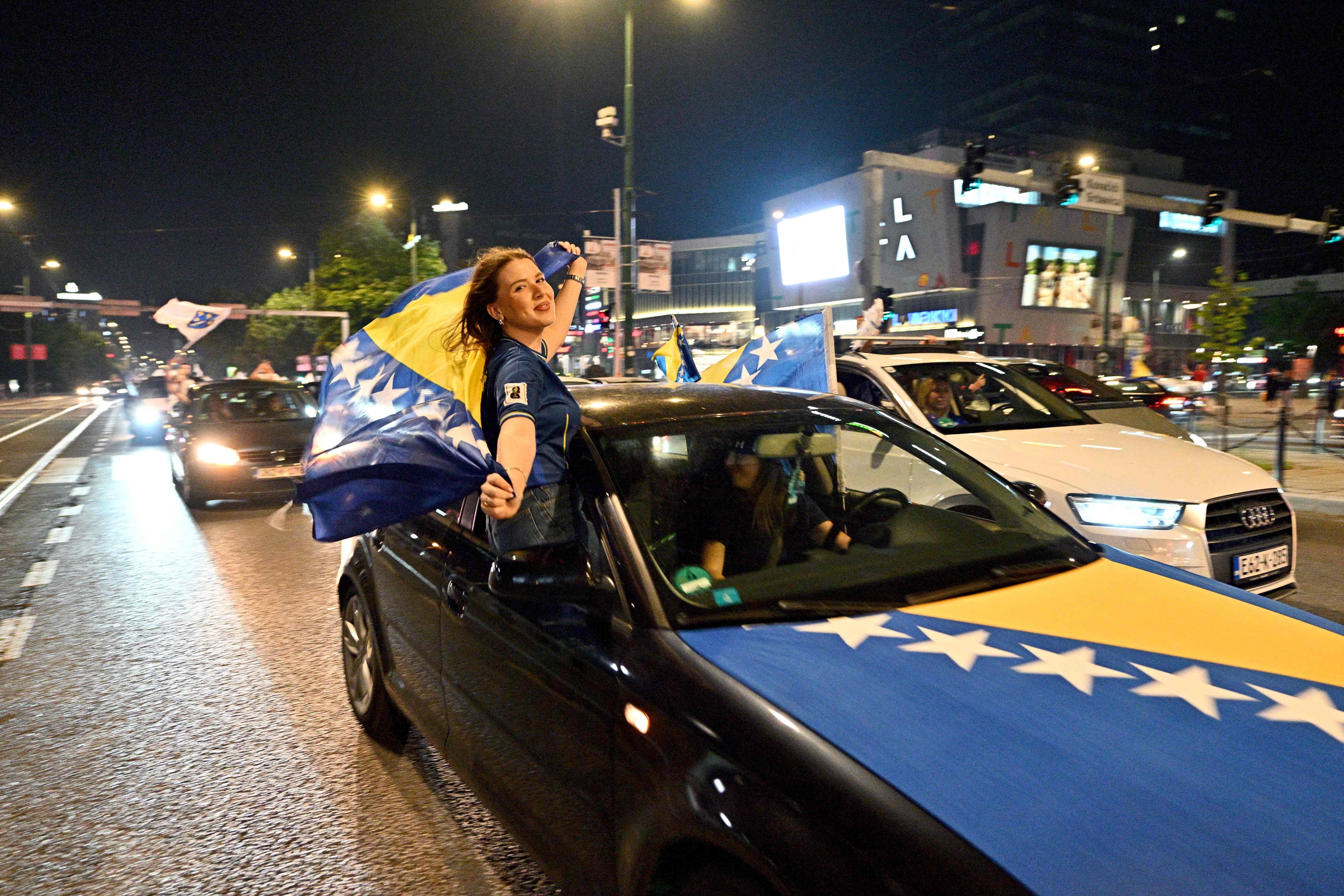 Bosnia and Herzegovina's supporters celebrate in the streets at the end of the Bosnia and Herzegovina World Cup 2026 football match against Qatar in Sarajevo on June 24, 2026. (Photo by ELVIS BARUKCIC / AFP)