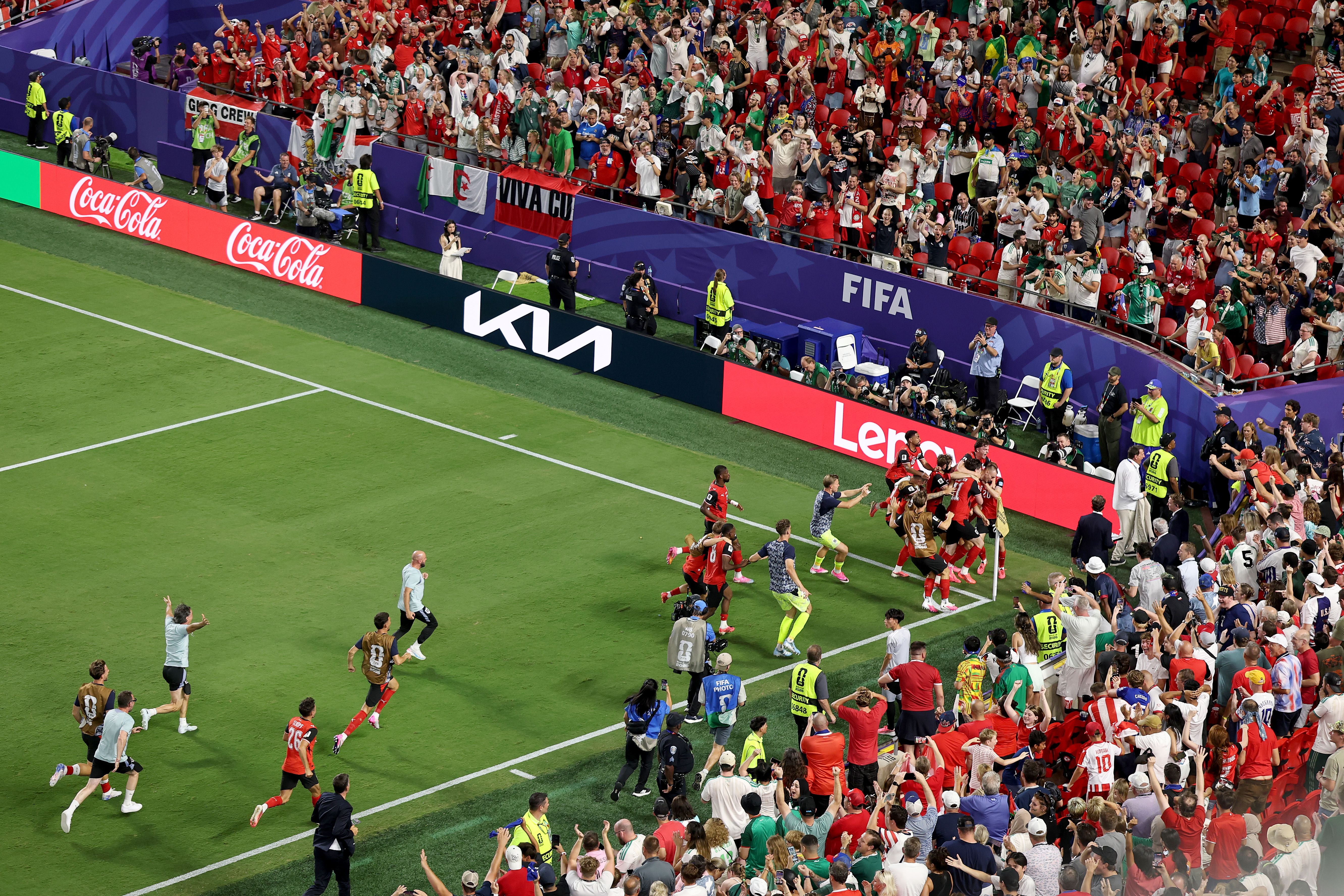 Österreichische Spieler feiern mit Fans nach einem Tor beim WM-Spiel gegen Algerien im Stadion.