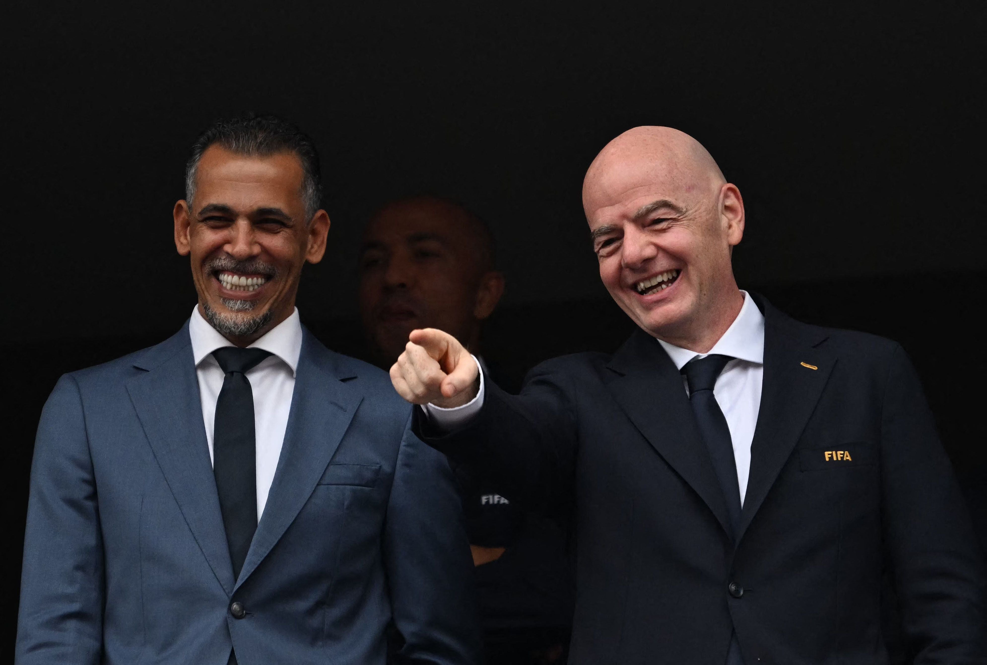FIFA President Gianni Infantino (R) gestures past Iraqi Football Association President Younis Mahmoud (L) during the 2026 World Cup Group I football match between France and Iraq at the Philadelphia Stadium in Philadelphia on June 22, 2026. (Photo by ROBERTO SCHMIDT / AFP)