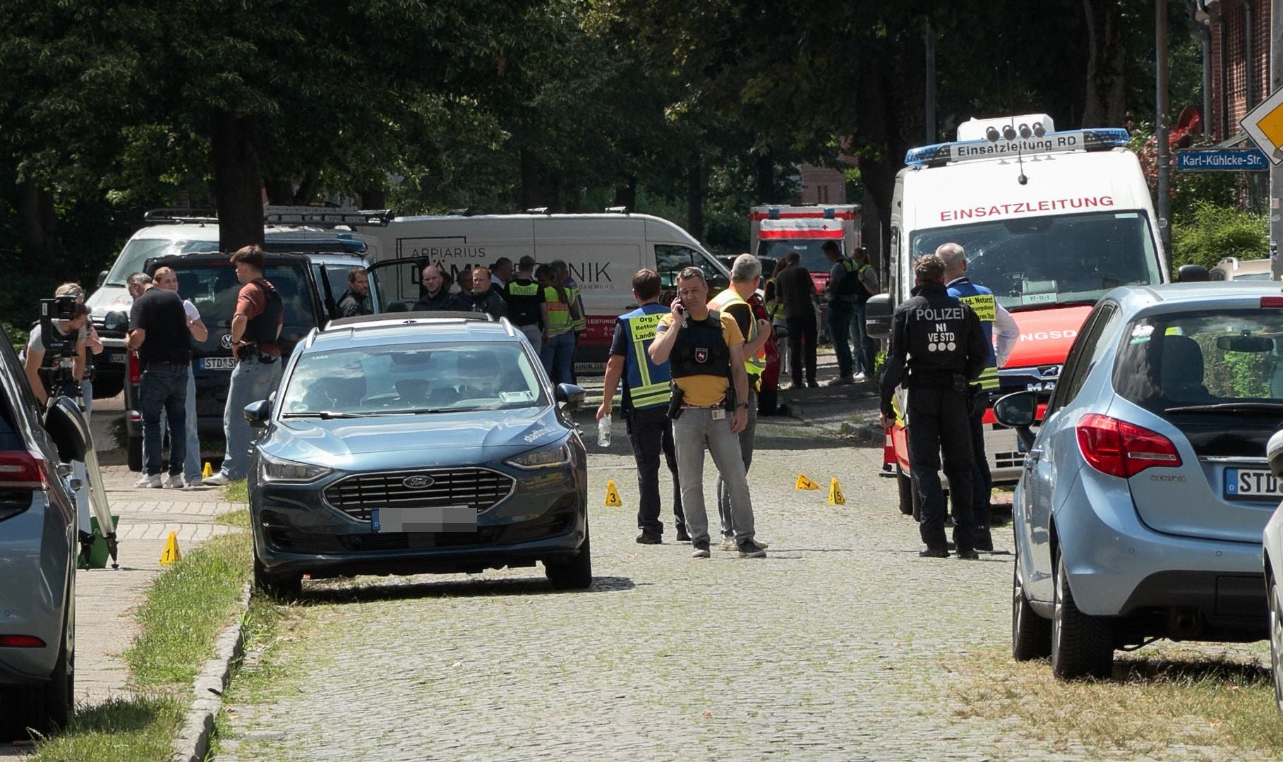Polizei und Rettungskräfte sichern einen Tatort nach einer Schießerei in Stade, Deutschland, ab.