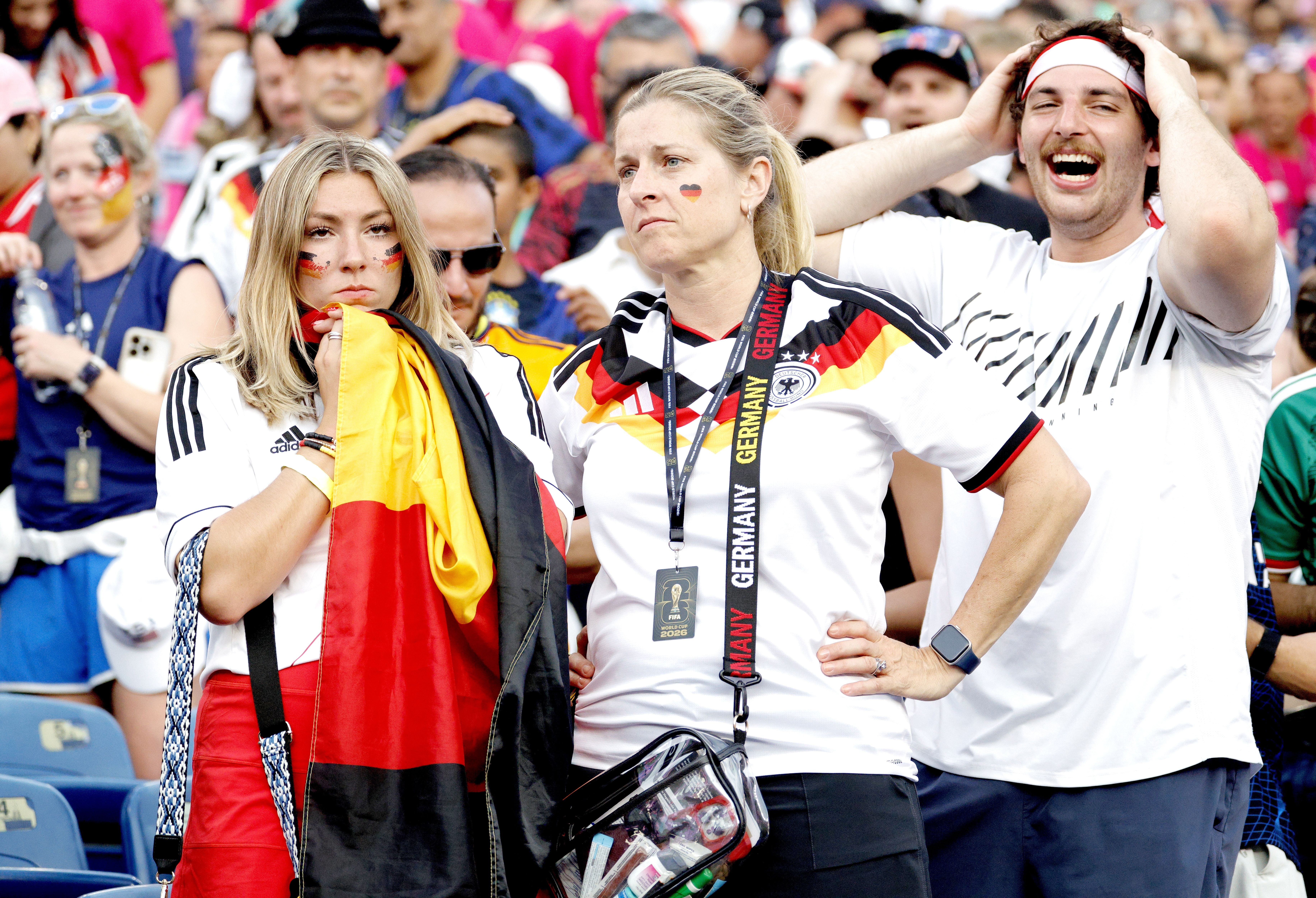 Deutsche Fußballfans im Stadion wirken enttäuscht nach einer Niederlage bei der Weltmeisterschaft.