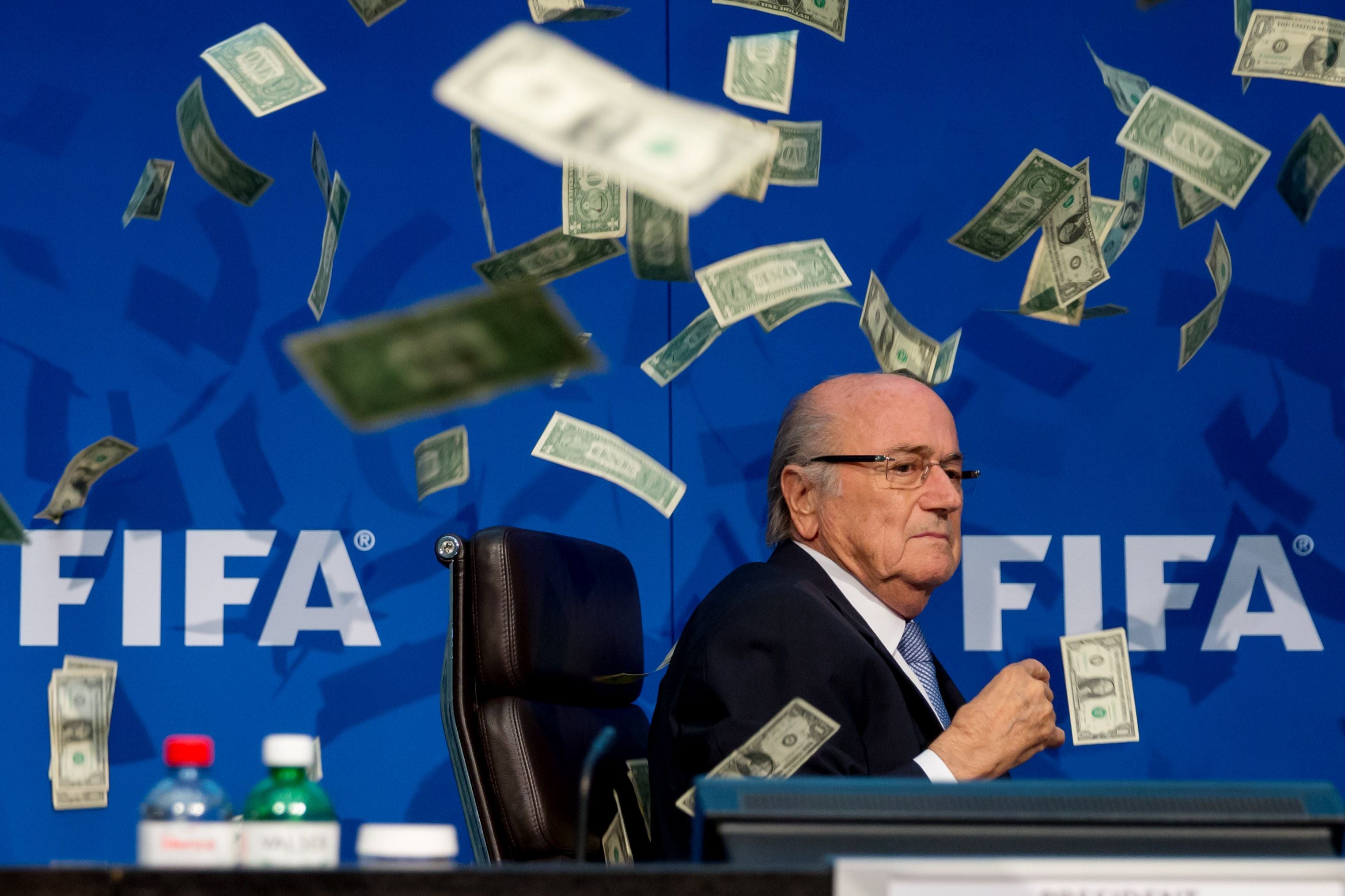 ZURICH, SWITZERLAND - JULY 20: Comedian Simon Brodkin (not pictured) throws cash at FIFA President Joseph S. Blatter during a press conference at the Extraordinary FIFA Executive Committee Meeting at the FIFA headquarters on July 20, 2015 in Zurich, Switzerland. (Photo by Philipp Schmidli/Getty Images)