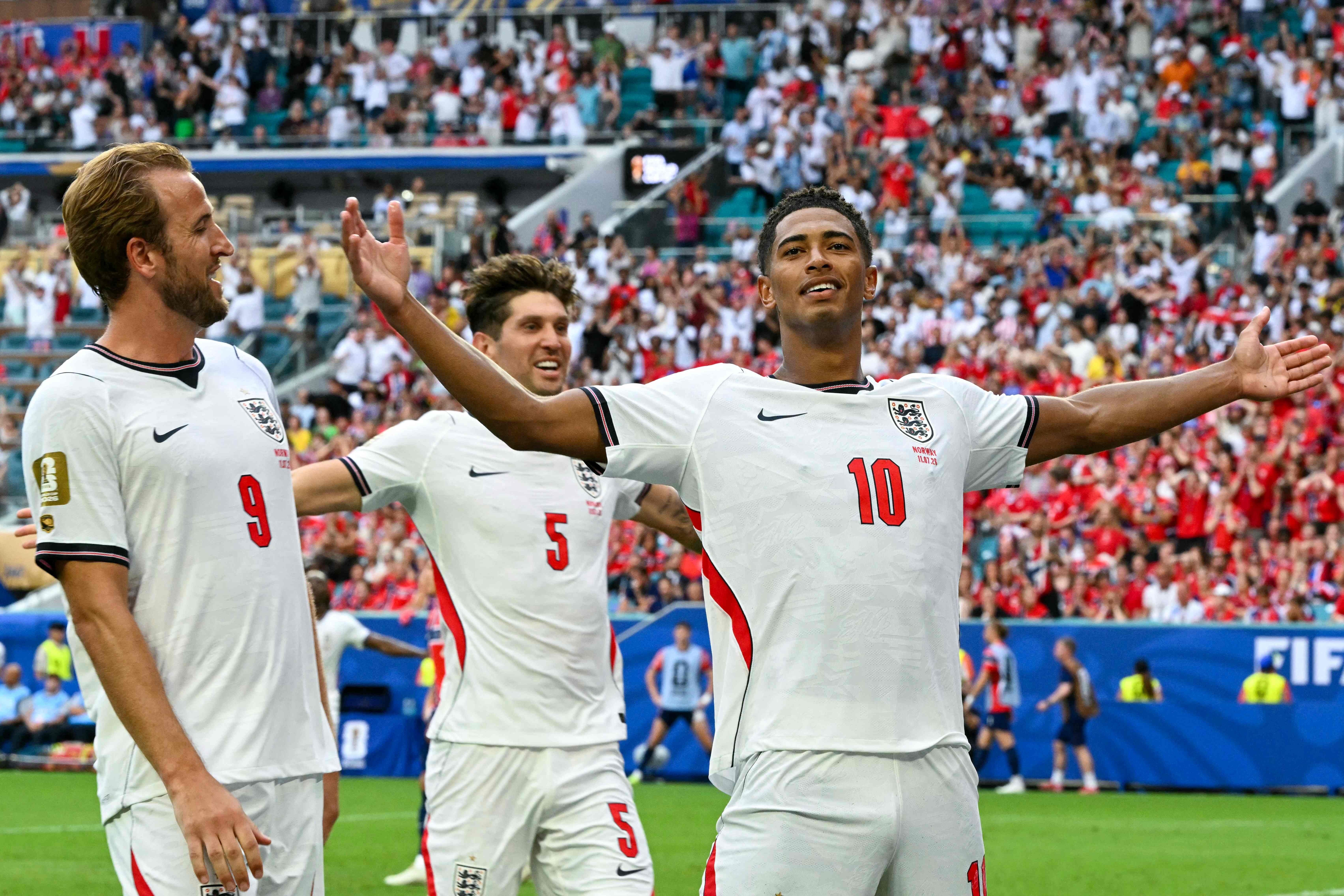 England's midfielder #10 Jude Bellingham celebrates scoring his team's second goal with England's forward #09 Harry Kane and England's defender #05 John Stones during the 2026 World Cup football tournament quarter-final match between Norway and England at Miami Stadium in Miami on July 11, 2026. (Photo by ROBERTO SCHMIDT / AFP)