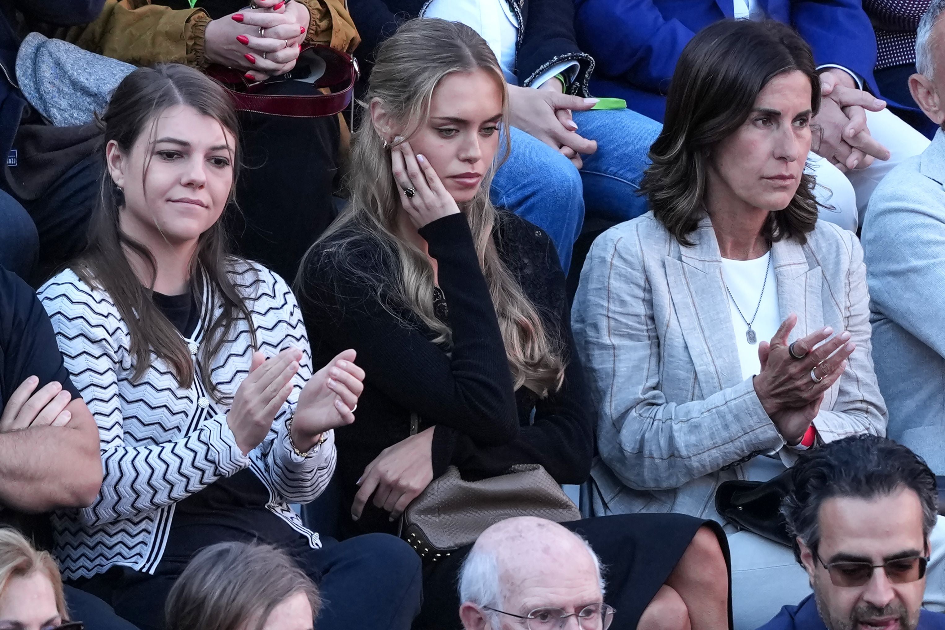 Drei Frauen sitzen nebeneinander im Publikum und beobachten aufmerksam eine Veranstaltung.