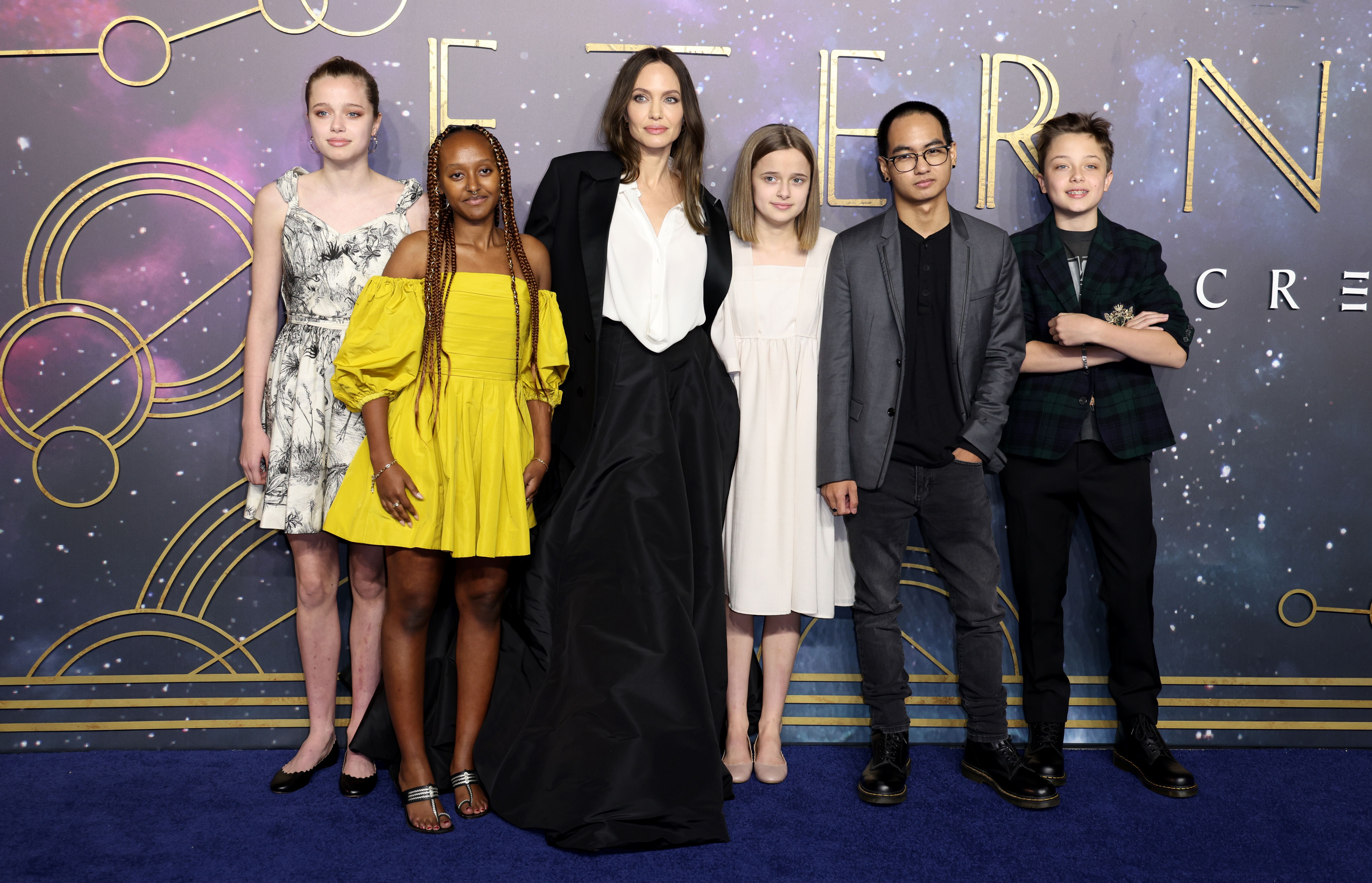 Angelina Jolie und ihre fünf Kinder posieren elegant auf dem blauen Teppich der "Eternals"-Premiere.