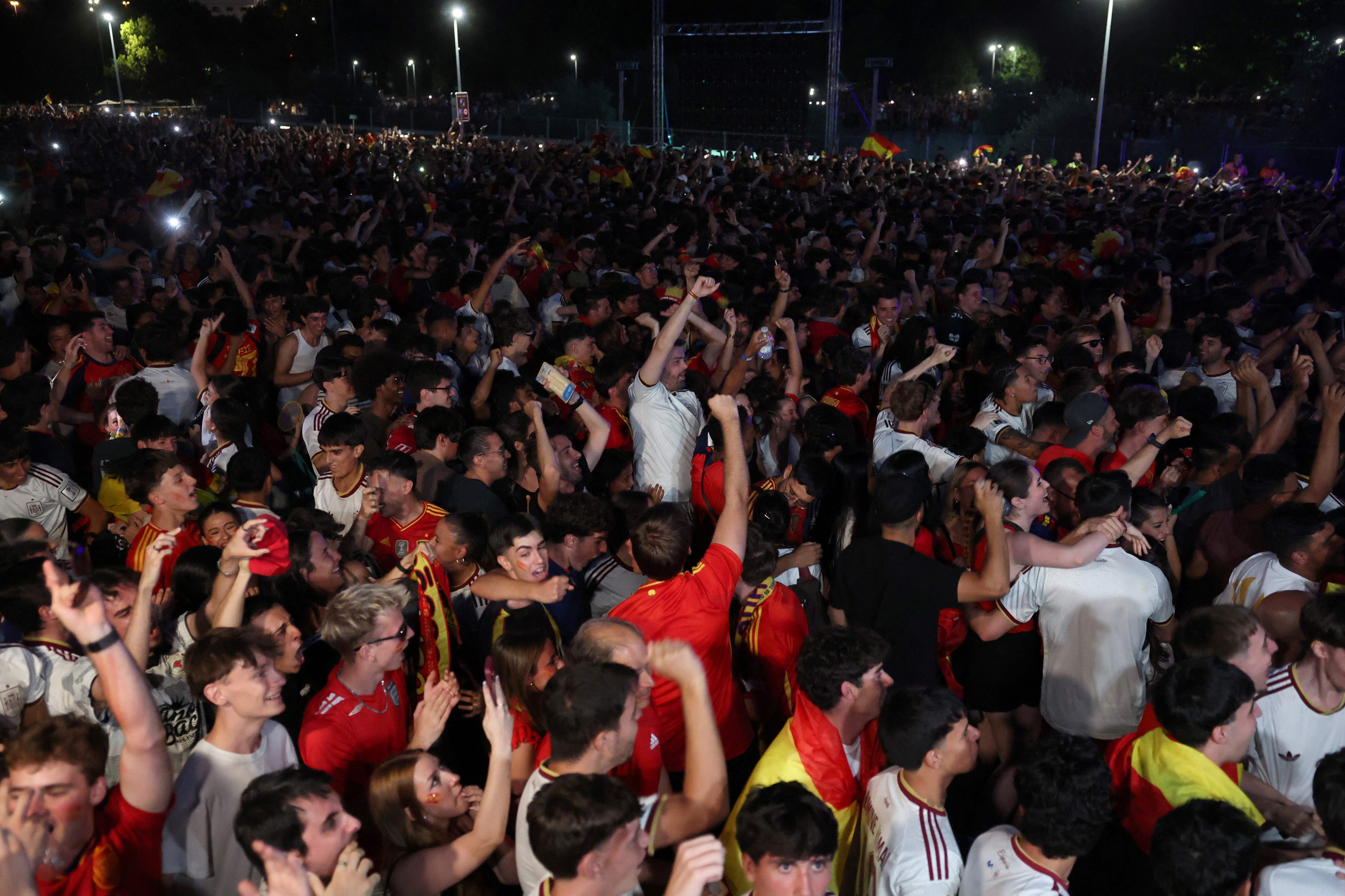 Spain's supporters celebrate their second goal during the 2026 World Cup semi-final match between Spain and France on a giant screen in 'Madrid Rio' fan zone in Madrid on July 14, 2026. (Photo by Pierre-Philippe MARCOU / AFP)
