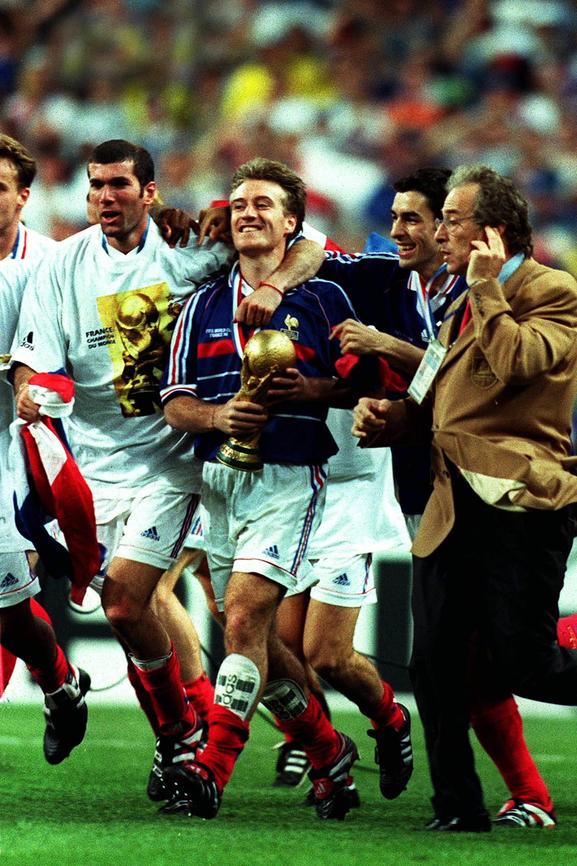 SAINT-DENIS, FRANCE - July 12: Zinedine Zidane, Didier Deschamps and Robert Pires of France With the World Cup Trophy celebrating after the FIFA World Cup Final match between Brazil and France at Stade De France on July 12, 1998 in Saint-Denis, France. (Photo by Stewart Kendall/Sportsphoto/Allstar via Getty Images)