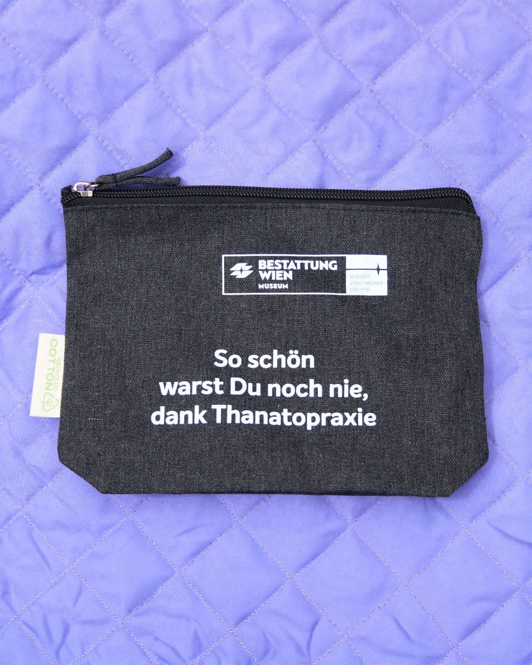 Schwarze Kosmetiktasche mit weißem Aufdruck: „So schön warst Du noch nie, dank Thanatopraxie“.