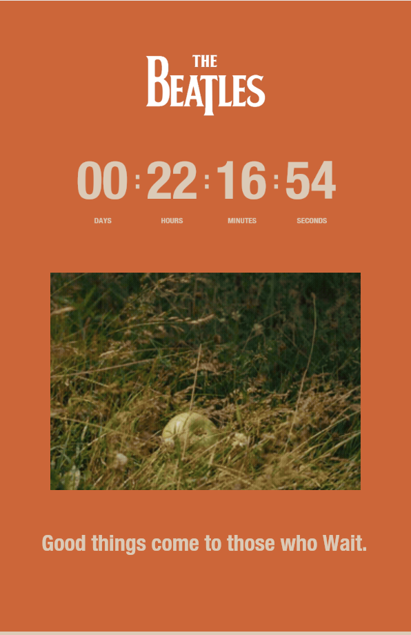 Countdown mit Beatles-Logo, Bild eines Apfels im Gras und Text: „Good things come to those who Wait.“