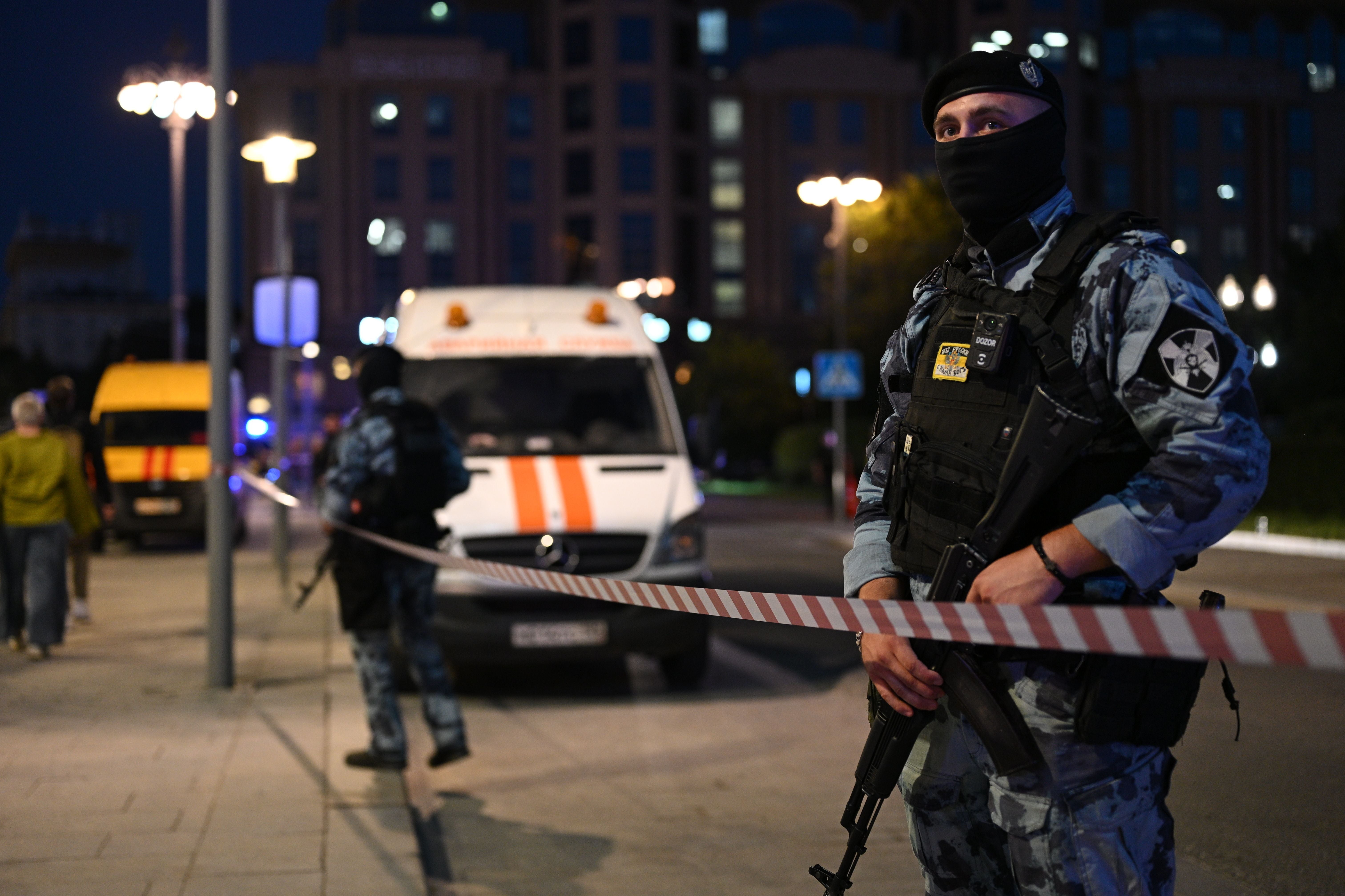 Bewaffnete Polizei sichert einen abgesperrten Bereich vor Krankenwagen in Moskau.