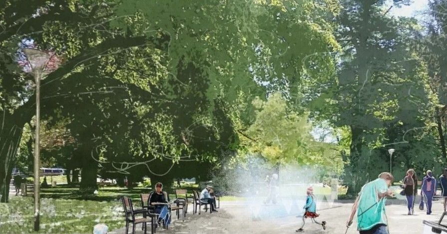 Menschen sitzen und gehen im Volksgarten, während aus dem Boden Nebel aufsteigt.
